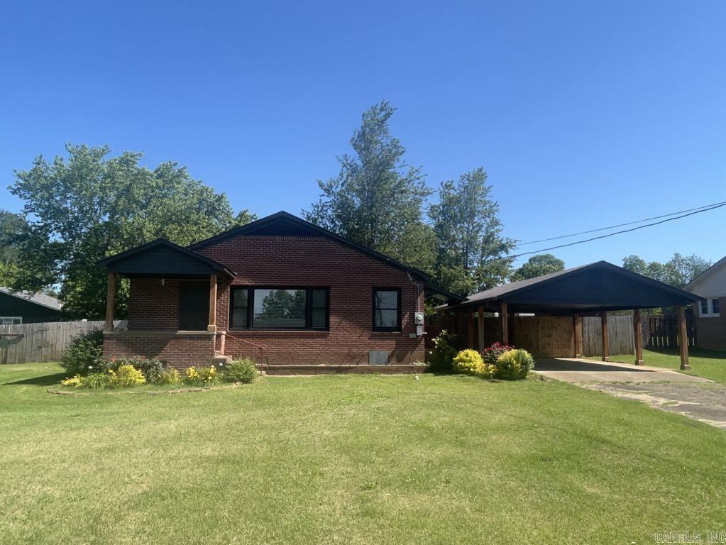 Attractive, well maintained brick home located on a quiet street in town! Features include gorgeous original hardwood floors, stainless steel appliances, granite countertops in kitchen and bathroom and a custom luxury walk in shower! There are 3 spacious bedrooms, large new windows throughout , plenty of built in storage space and! Step outside and notice a fully fenced private backyard, a covered back patio, and a carport connected to the side entrance! The home is fully furnished with tasteful, quality furnishings. This property would make an amazing primary residence or rental!