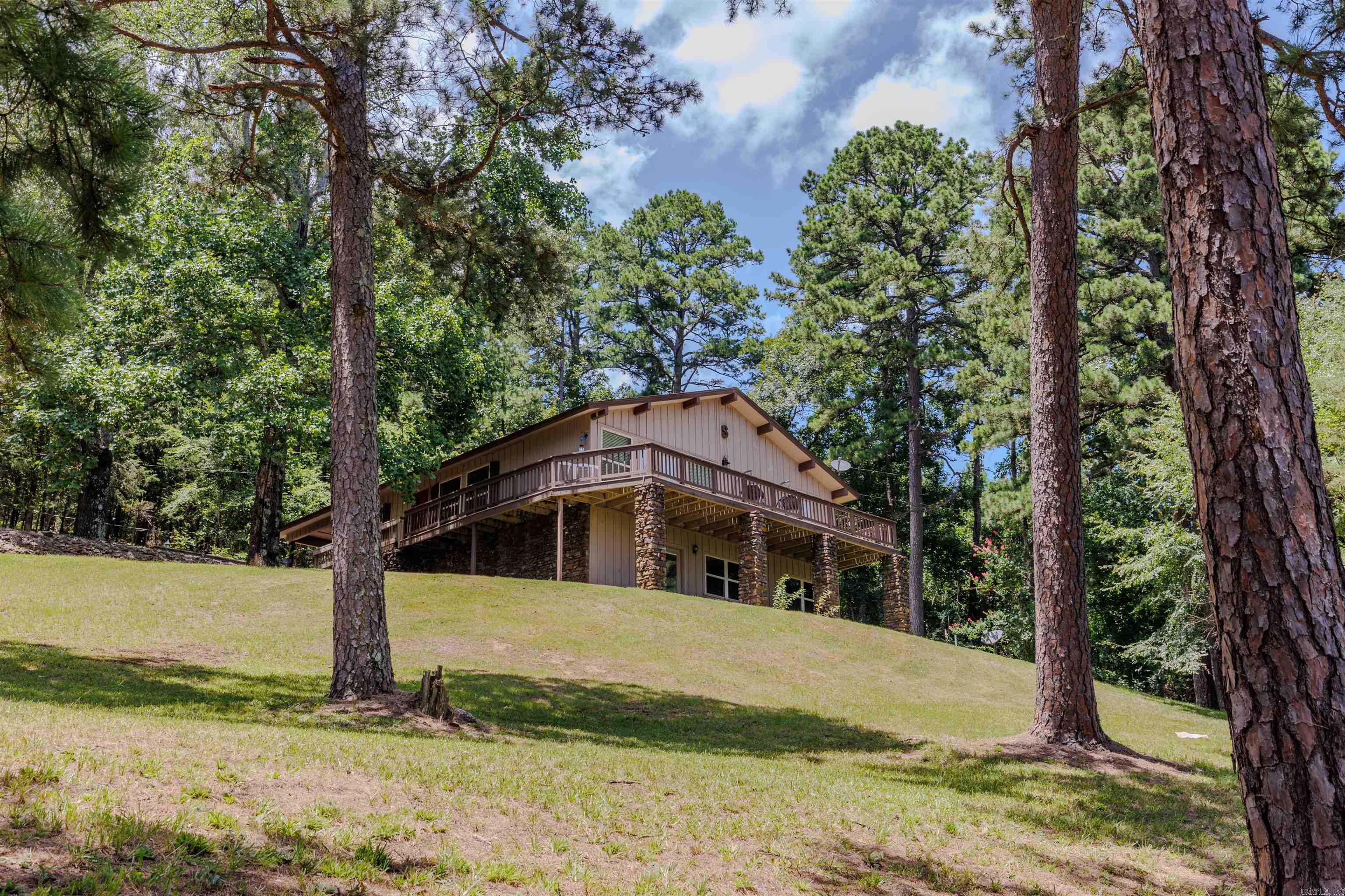 This home is perfect for multi-generational living and sits on 5 acres, where wildlife roams plus amazing views from the wraparound porches! There’s also a shop with electricity and an old farmhouse on the property that could be fixed up or torn down—your choice. On the main floor, you'll find 2 bedrooms, 1 bathroom, an updated kitchen, an office, a living room, and a laundry room (which could easily be turned into a 3rd bedroom). Total main floor square footage is 1,630. The basement adds another 980 sq/ft of finished space and includes a living room, bedroom, bathroom, laundry area, and even a bar! Both levels have French doors that open to the outside, making it easy to enjoy the peaceful surroundings. Recent updates include a brand new HVAC system, new furnace, a freshly remodeled kitchen, dehumidifier and complete remodel of the basement. Fiber internet is available through Connect2First, so you're all set for remote work or streaming.