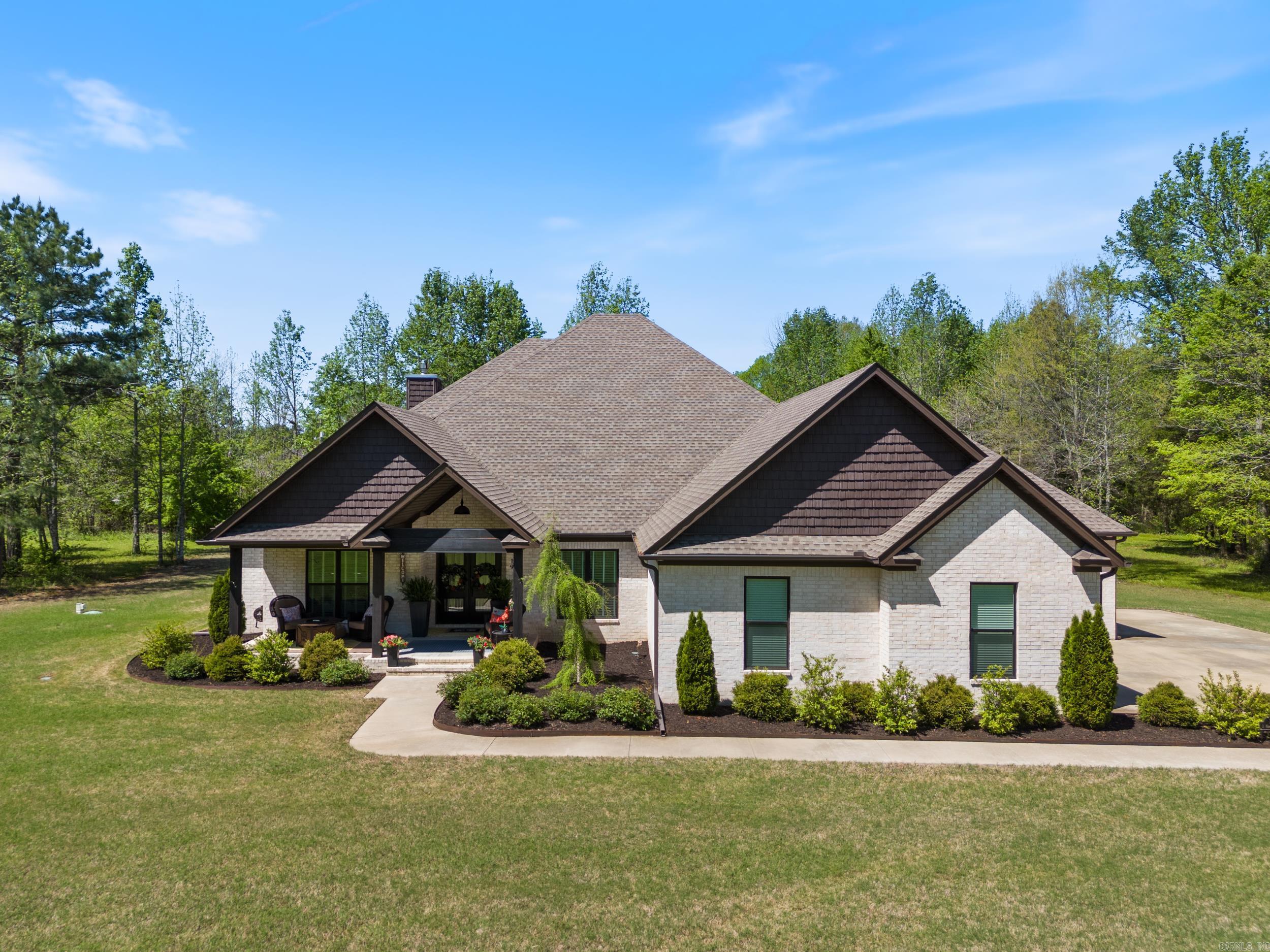 LIKE NEW custom built farmhouse style home nestled on over 5 acres! Welcome home to your luxury oasis. This immaculate one-level home with the desirable open, split floorplan, boasts high end finishes & upgrades throughout. Featuring 4 spacious bedrooms, each with its own walk-in closet, office, dining area and a huge bonus room that can be utilized as a media room or second living area. With 3.5 bathrooms, including a luxurious primary en suite, and a large laundry room, convenience meets sophistication at every turn. The huge bonus room can be utilized as a cozy den or media room. The chef's kitchen includes granite countertops, huge island, lots of cabinets & counterspace, coffee bar and walk-in pantry for all your culinary delights. Entertain in style or simply unwind on the amazing covered patio offering the perfect cozy setting with an outdoor fireplace. The beautiful professional landscaping with sprinkler system provides curb appeal and ensures a seamless transition from the exterior to the interior. Enjoy the country feel with the convenience of just being minutes from the highly rated Greenbrier schools, restaurants and shopping. Wonāt last long! Agents see remarks.