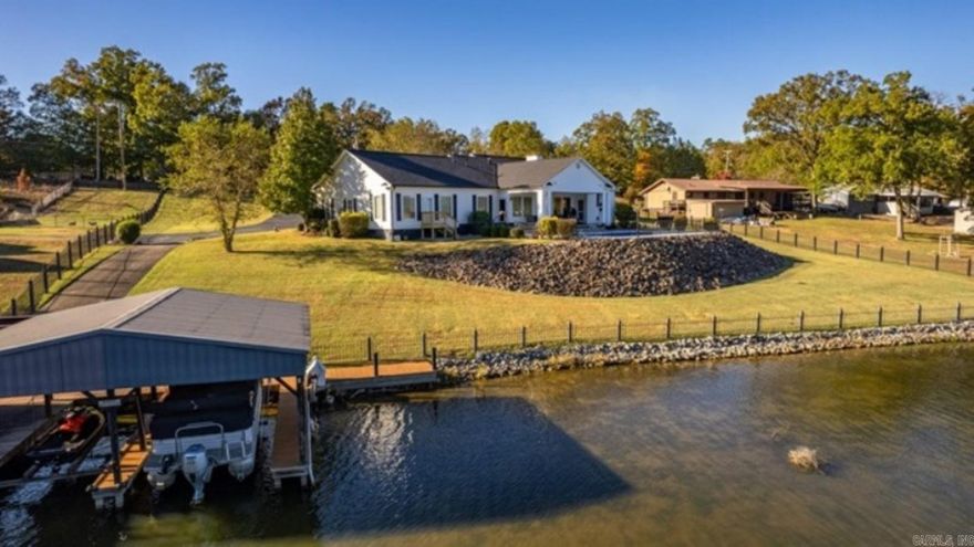 Completely updated inside and out! Come see this beautiful lake home with bonus guest house for your family and friends. From the moment you enter through the gates you will fall in love with the large front porch and back covered patio with southern columns that make you want to sit and visit. Throughout the homes you'll find new luxury plank flooring, new HVAC systems, granite fireplace and central vac. The main house features large rooms and a wall of windows overlooking the pool and lake. Outside boasts poolside granite tables, new pool liner, full size cover and variable pump system as well as decorative concrete and new pool fencing. As you make your way down to the water you may notice all new re-zoned PVC, high-pressure sprinkler heads and pump along with a new seawall and boardwalk. Both homes are getting new roofs, gutters and siding. The main house is 2864sf and the guest house is 1014sf (garage sf not included in measurement). Priced to sell so call today for your private tour.