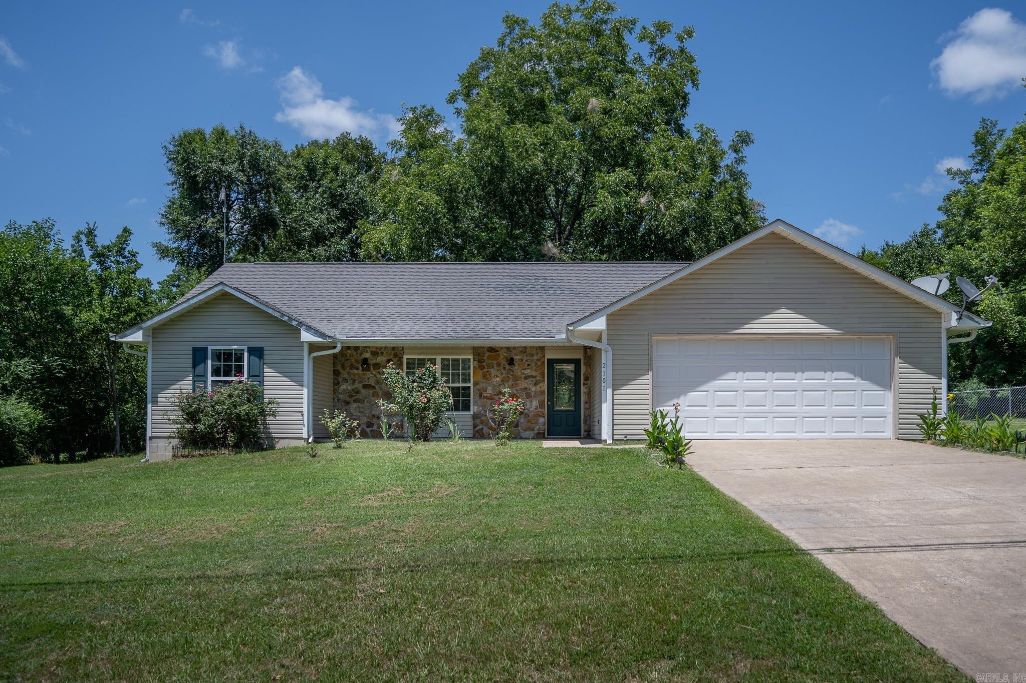 What a nice place to call Home! A full half acre in a peaceful neighborhood in town with plenty of outdoor space for your family the shaded back yard. This 3 bedroom 2 bath has an ideal floorplan and open concept main living area that feels even more spacious with the vaulted ceiling. The convenient "U" shaped kitchen makes meal preparation a snap and all appliances convey. A private hallway leads to the primary bedroom and ensuite with a walk in shower and roomy closet. On this same wing of the house you will find the laundry/half bathroom, new water heater, and exit into the 2 car garage.