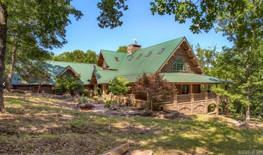 Incredible 224-acre estate w/over half a mile (~3500ft) of White River frontage—just outside Fayetteville. A nature lover’s & sportsman’s paradise w/wildlife, two ponds & breathtaking views. The 9,920sf custom log lodge features hand-hewn logs, custom doors, 5 stone fireplaces, stacked stone exterior, geothermal heated floors, metal roof & elevator. Inside: 4 beds, 5 baths, loft & safe room/full separate apartment. Massive 44’ x 36’ great room is perfect for entertaining, events, or retreat use. Over 3,800sf of covered porches, balconies & patios provide seamless indoor/outdoor living. Also on the property are 2 guest homes (~1250sf each, not included in listed square footage), a tiny cabin, greenhouse, barns, goat & horse stables, chicken coops, metal buildings & original homestead water well. Fenced & cross-fenced. Endless potential as a private estate retreat, working farm, or event venue. City water/electric. Built in 2002 with exceptional craftsmanship. Sold as-is. Some finishes required. Appointment only.
