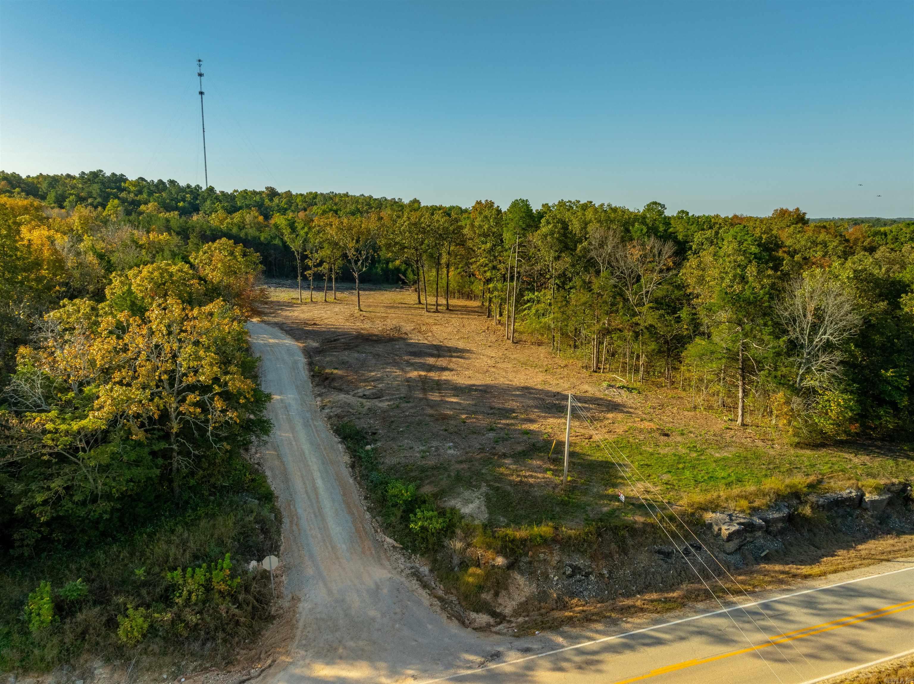 Ready to built that new home or set a mobile? WE HAVE YOUR LAND! This newly available 55+/- acre property is ready for your dream home! Whether you're looking to build a house or set a mobile home, this land is cleared and offers the perfect spot for your homeplace. With no restrictions, you have the freedom to create the lifestyle you desire. Evening Shade water and NAEC for electricity are available at the road, making the setup process easy! The property is ideally located within a mile of a gas station, Dollar General store, and a bank, providing convenience while still offering plenty of privacy. With both gravel road frontage and Highway 56 frontage, access is a breeze. In addition to the cleared area for your home, the property also features wooded sections perfect for hunting. Just a few minutes' drive down 56 highway takes you to the scenic Strawberry River, and you’re only about 10 miles from Cave City, Arkansas. Plus, it's a short 30-minute drive to Batesville or just 15 minutes to Ash Flat, offering quick access to nearby towns. This unrestricted land provides a rare opportunity for flexible living in a peaceful, natural setting with modern conveniences close by.