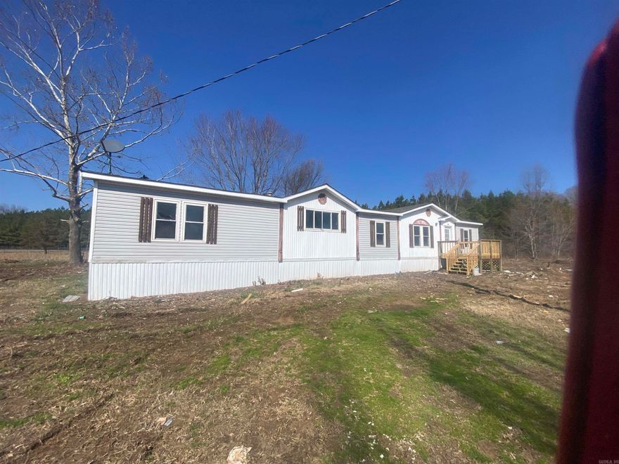 Four bedroom home with a split bedroom plan, two living areas, open concept, large deck all sitting on 5 acres.  Master bath has a large jetted tub, shower, double vanity and a makeup area.  Master has a room off of it that would be a great offcie or dressing area. Kitchen has a breafast bar/island and tons of counter space.  New exterior and interior paint, new flooring.  Come check this one out today.  Home is on a permanant foundation