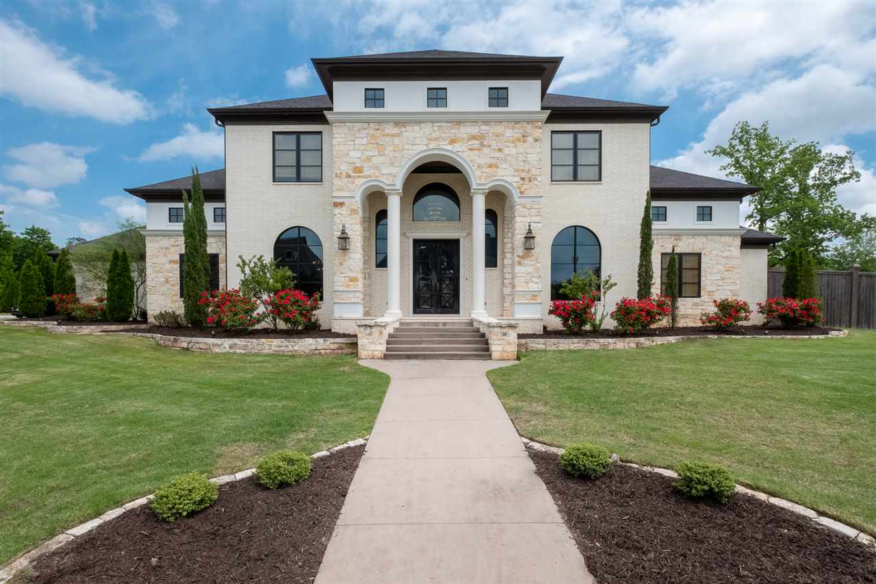 Spectacular home in intimate gated community. Beautifully landscaped on a lot and a half. Vaulted ceilings, exposed beams, chef's kitchen,custom wine closet, unique ceilings differentiating space, Home is automated (Control-4) Custom front doors from Brazil, Staircase and balcony railing from Italy.Theater room with 150" screen and HD projector with 3D capability and state of the art sound. Tankless water heaters. Hidden safe room in Master. Automated blinds. Oversize 3 car garage. COME SEE!!!!!!