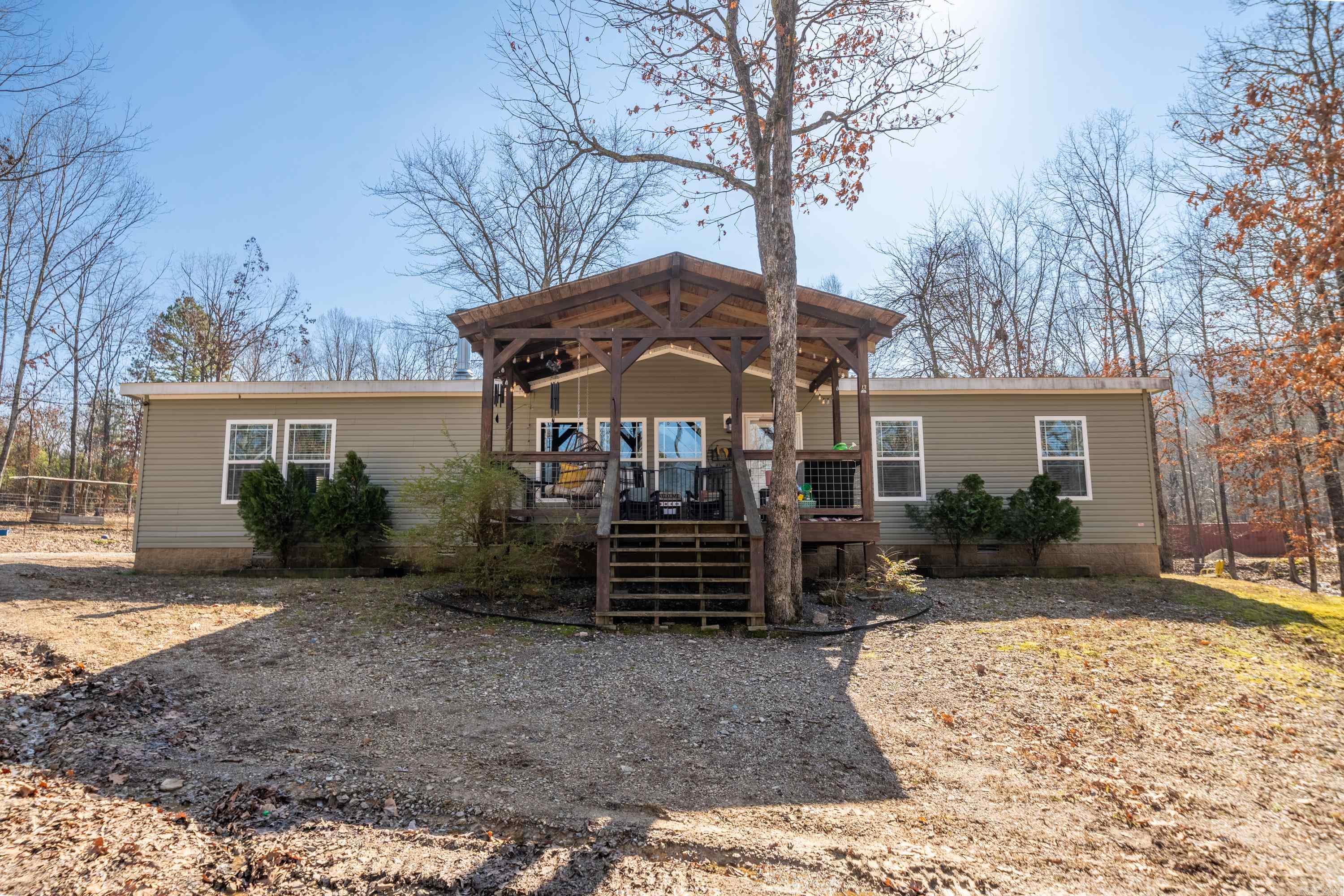 Country roads take me home! This gorgeous custom-built manufactured home is ready to make your country dreams come true. Built in 2017, the interior is exuding with rustic charm. From the wood burning stove, luxury vinyl plank flooring, crown molding, walk-in pantry, stainless steel appliances, and french doors, this property is sure to make you feel right at home as you walk in the door. The master suite features dual vanities, tiled walk-in shower and bathtub, and a spacious walk-in closet. Immerse in peaceful mornings on the front porch with a cup of coffee, or enjoy a cozy night by the fire in the backyard firepit. Outdoor features a 30x40 shop, RV hookup, and fencing for livestock, all on over 3 scenic acres.