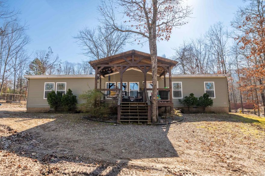 Country roads take me home! This gorgeous custom-built manufactured home is ready to make your country dreams come true. Built in 2017, the interior is exuding with rustic charm. From the wood burning stove, luxury vinyl plank flooring, crown molding, walk-in pantry, stainless steel appliances, and french doors, this property is sure to make you feel right at home as you walk in the door. The master suite features dual vanities, tiled walk-in shower and bathtub, and a spacious walk-in closet. Immerse in peaceful mornings on the front porch with a cup of coffee, or enjoy a cozy night by the fire in the backyard firepit. Outdoor features a 30x40 shop, RV hookup, and fencing for livestock, all on over 3 scenic acres.