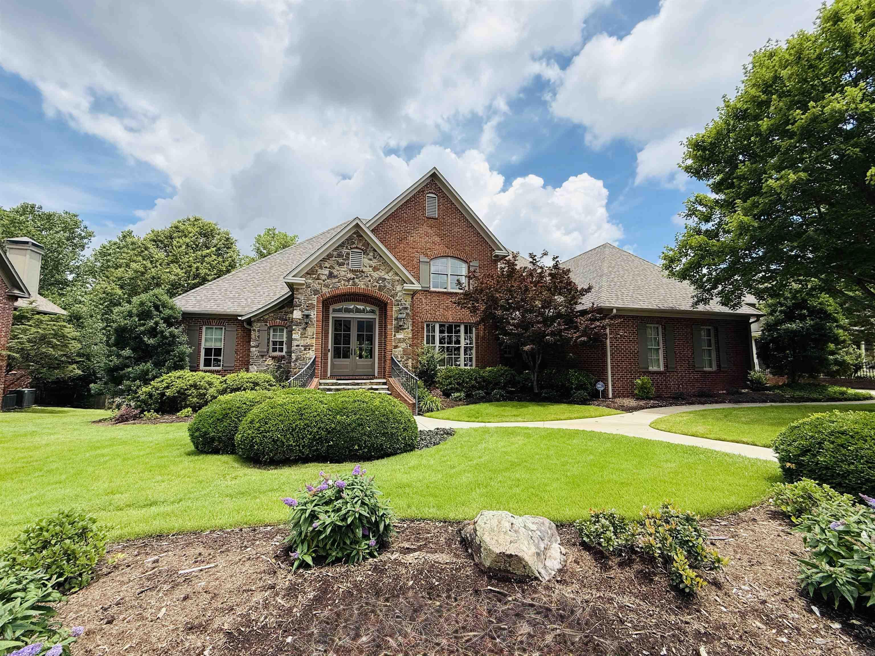 Amazing home nestled in the Lamarche neighborhood of Chenal. This custom-built home has been meticulously maintained and a delight for entertaining family and friends. From the elegant entry find the formal dining room with butler pantry, greatroom with wall of built-in and french doors to a tiled balcony overlooking lush green space. The chef's kitchen is well appointed with top-of-the-line appliances, breakfast bar, separate breakfast room that is open to large hearth room with wbfp. The updated primary suite is on the main level with double vanities, tub, shower & walk in closet as well as laundry room and half bath. Upstairs find 2 ensuite bedrooms with walk-in closets and walk-out storage. Downstairs, find an additional family room - gameroom with kitchen and dining area as well as bedroom and full bath. Enjoy peaceful entertaining on the covered back patio overlooking the lovely landscaped backyard and greenbelt.