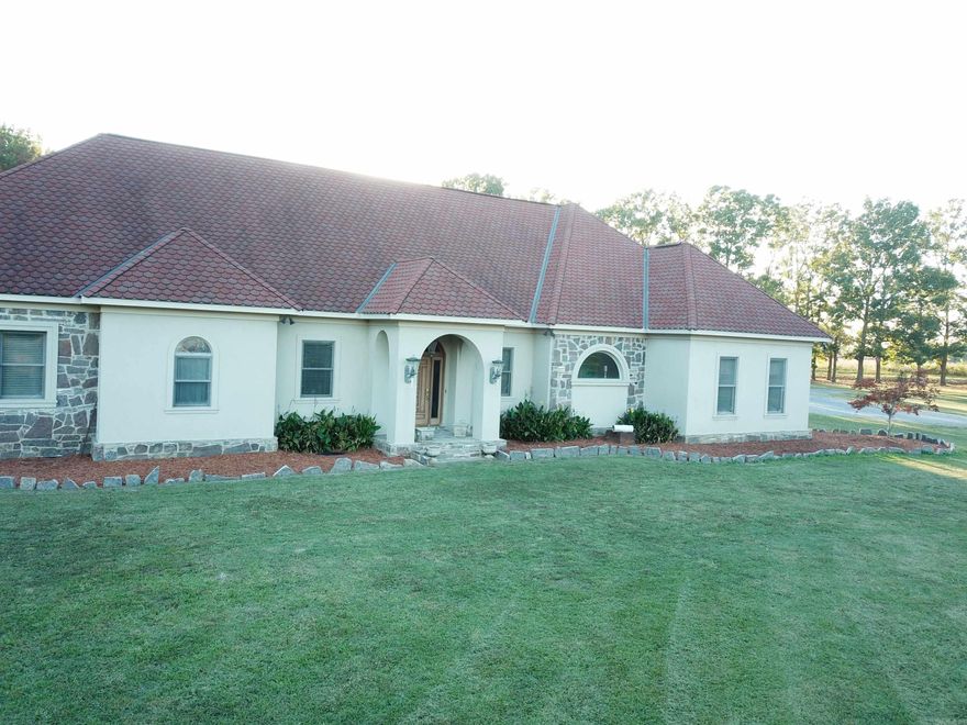 3 Bdrms & 3 Bths down stairs.  2 Bdroms dwnstrs w/walk-in closets w/dressing tables built in w/big mirrors. Master his & her closest w/built in Chester Draws.  Hacket Rock Fireplace w/hearth, mantel, cathedral Ceiling, slate floor, custom cedar closet doors and trim.   Master whirlpool bath w/ sep large shower and his and her separate vanity w/marble tops, private toilet, pocket door laundry pullout built in cabinets. 2-heater/vent fans in ceiling.  Walk-in closet by master hallway and 3 closets down hall way. 2nd bathroom has tub and a shower, marble countertops, slate floors, sinks and small closet. Office has closet, tray ceiling, floored electrical.  Arched entries throughout.  Dining room can lighting, tray celing, wood floors.  Breakfast room, tray ceiling.  Kitchen cabinets are Maple w/2 islands, 34 drawers, baking pans/cookie sheet, built in cutting board, granite and small island plumbed with sink.  Laundry has Maple cabinets, built in ironing board, sink and drain in floor. Den has fireplace w/insert, mantel, Hackett Rock, flagstone floor. Hallways Flagstone Porches and Walkways has Blue Stigler Stone. Six Inch Walls. Roof Architectural Shingles Georgian Brick