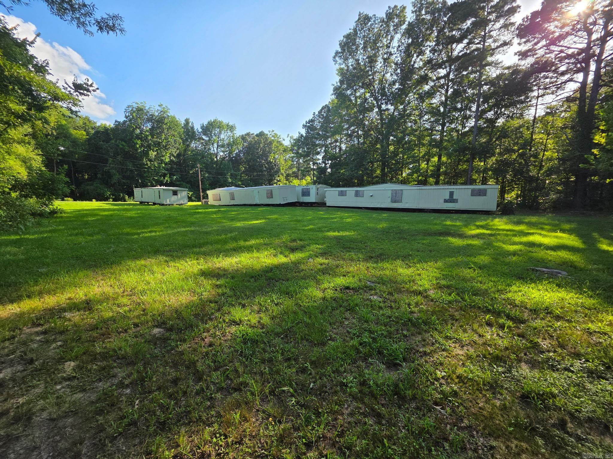 Great Investment Opportunity! This unique property offers four mobile homes situated on 0.50 acres in a peaceful country setting. Each home is positioned with access to electric, city water, and city sewer already on-site, making it ideal for rental income. Whether youāre looking to build your investment portfolio, create a multi-family living space, or generate passive income, this property has endless potential. Conveniently located with country charm, yet not far from town. Donāt miss out on this versatile opportunityāschedule your showing today!
