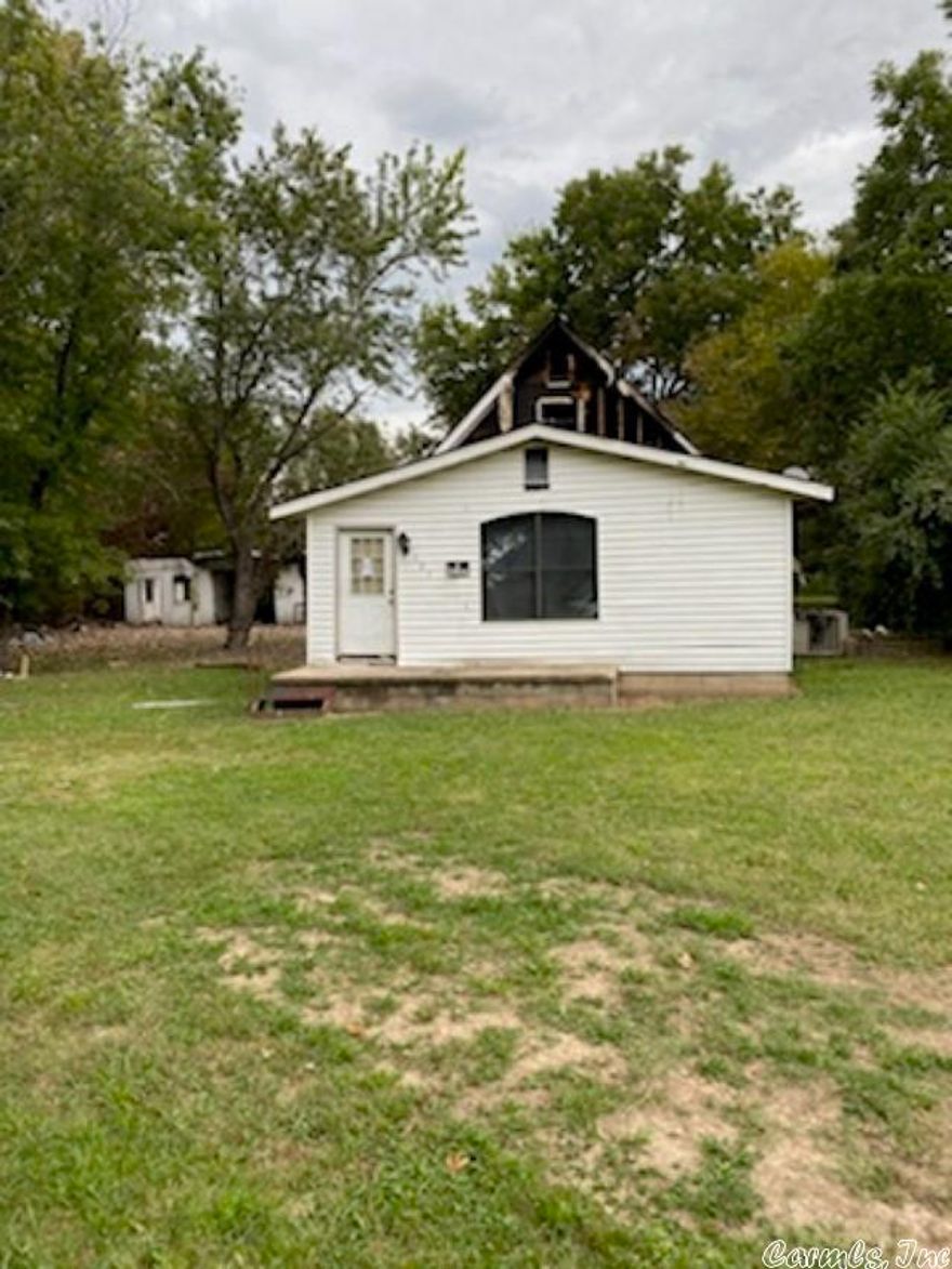 Tree shaded lot in city limits.  The home and shop/apartments that were on the lot have been burned and seller is selling land value only.  The existing home was 1272 sq ft with basement.  Building in back at one time had three apartments but was being used as a shop by previous tenant. A survey will be required to obtain the exact acreage of property.