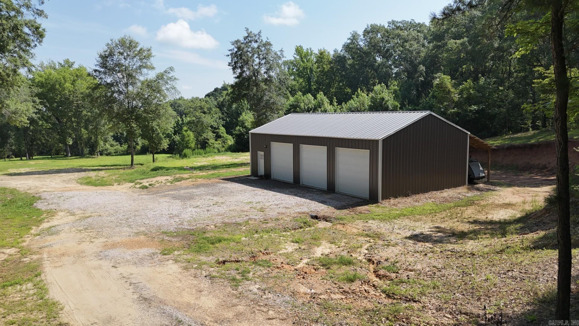 Welcome to 1442 Country Club Road, a 40-acre haven bordering Arkadelphia city limits. Only 5 minute drive from OBU/HSU campus and 13 minutes from Lake Degray. This beautiful property is mostly wooded, ideal for hunting, featuring a private pond. Access from both Country Club road and Herrin lane. Come inside to find the newly built 2-bed 1-bath shop home designed not only for comfort but functionality. The home features an open layout that flows seamlessly from the kitchen, dining area, and living area. The home's 12-foot walls give an ample feel. The beautiful, cleared yard is perfect for gardening, play, or a building site. The home has an attached garage space ideal for protecting your vehicle or workshop space. A 10x50 side shed around back offers more storage and workspace. Picture endless possibilities on this extraordinary 40-acre woodland canvas, whether you envision your dream home, development, or a farm. Do not miss your chance to call 1442 Country Club Road your own! MOTIVATED SELLERS make an offer!