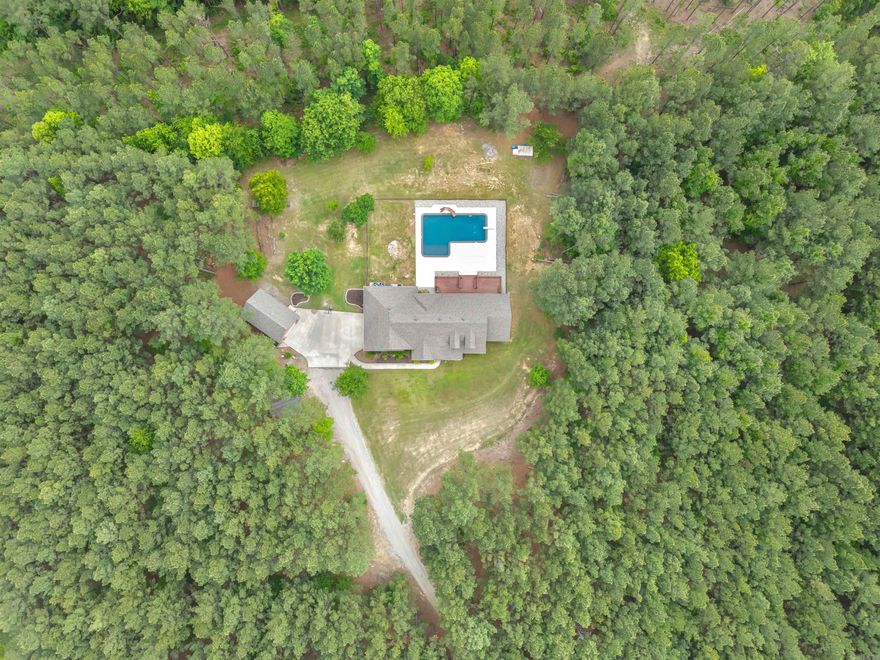 Tucked away in the Ouachita National Forest and Winona Wildlife Management Area, this custom home sits on 9.87 acres in a rural, country setting! Enjoy the convenience of being within 35 minutes to Conway and Little Rock, but the privacy of country living. The NEW in-ground pool is PERFECT for entertaining! The deck has been reinforced and wired for a hot tub! Inside the home features 4 bedrooms, 3.5 bathrooms, great room and a bonus room! All closets are generously sized, with the master being a huge walk-through closet. The custom kitchen features quartz countertops, an induction cooktop and convection oven, with a HUGE walk-in pantry. The main living areas feature 12' ceilings with rich crown molding and custom blinds. The home features 16 SEER HVAC units, newer roof with 30 year architectural shingles and LVP flooring - 2022. The home has an oversized garage and a 20x30 detached garage/shop, which features a full bathroom, washer/dryer hookup and electrical. New in-ground basketball goal makes a nice feature for families! *Fiber Internet & City Water*