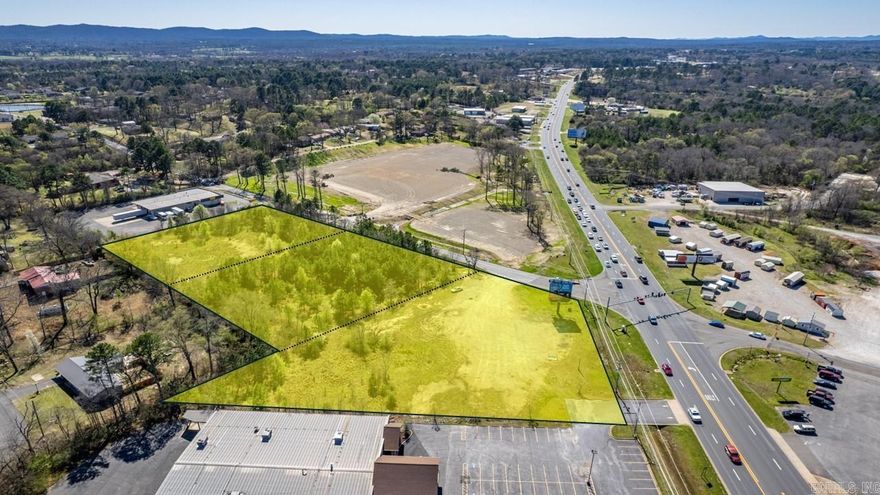 2 acres at prime commercial corner with 200+ frontage on busy Hwy 70W (21,000+/- cpd) at stoplight intersection. Level lot with access on two sides in an area of commercial growth. All city Hot Springs utilities available,  additional 3+/- adjacent acres available. Billboard lease does not convey.