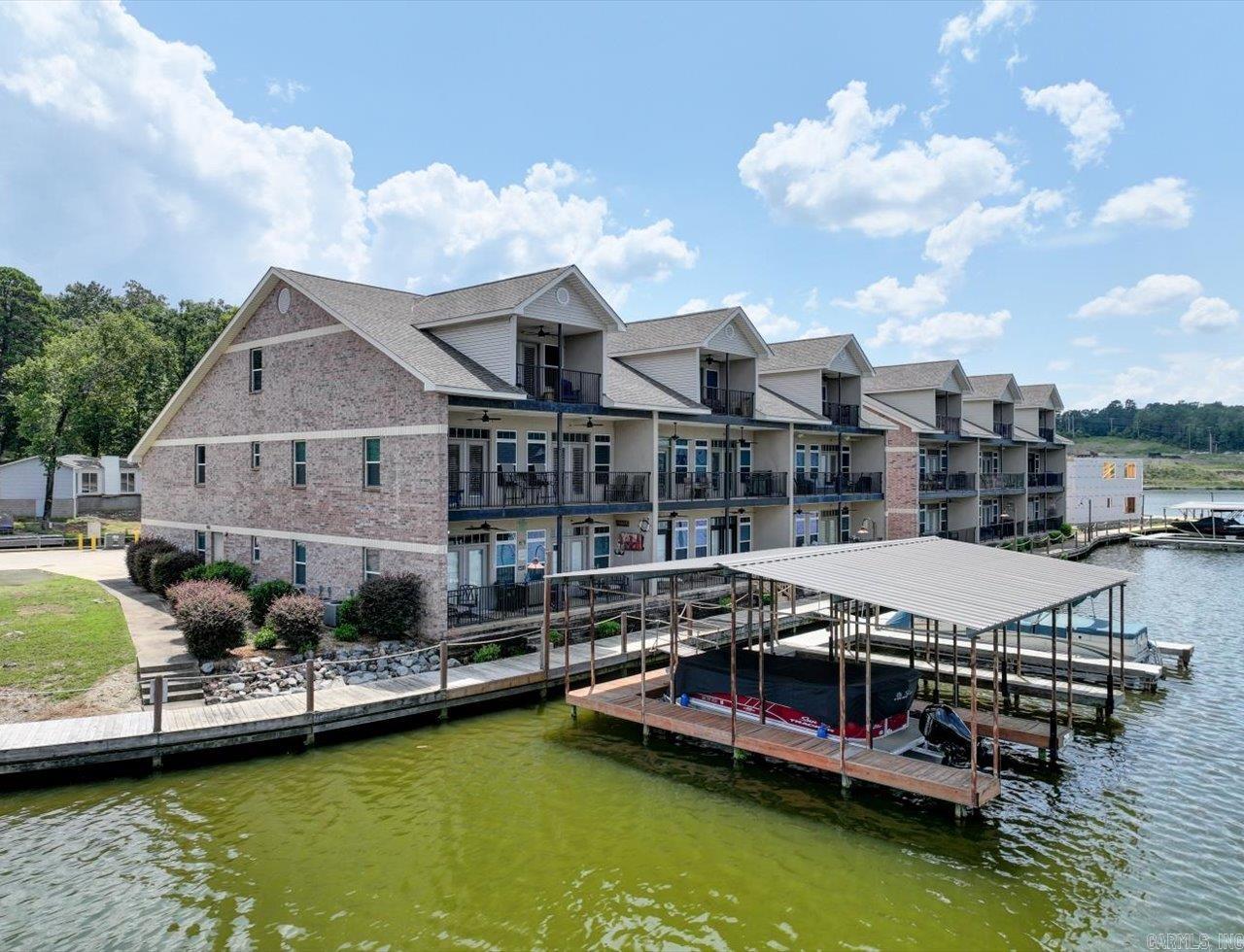 Lakefront Luxury on Lake Hamilton - Gated Condo with Exceptional Amenities. 3 bedroom 3 bathroom condo in a sought after gated complex on Lake Hamilton. The private master suite occupies its own floor for maximum comfort, while two levels of sunset-facing balconies invite you to start your day with coffee or wind down with evening views over the water. Inside, you'll find a polished color palette, modern lighting, and stylish decor. Nightly rentals are allowed-making this an ideal investment for winter race season, holiday getaways, or summer weeks. This rare unit also includes an enclosed garage, private boat ramp, trailer parking, and its own boat slip. Conveniently located with easy access to the interstate and just minutes to dining, shopping and entertainment. Lakefront living, investment potential, and everyday comfort-this one checks every box.
