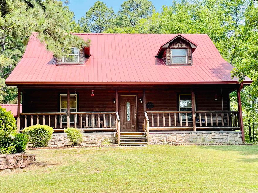 Beautiful rustic log siding house on almost 3 acres!!! Oh and did I mention the 30' X 35' Shop Building??? Plus a detached 2 Car garage with covered walk to the back patio with a tin roof - remember sitting on grandma's porch with a tin roof and listening to the rain!!!  Oh my!! Main floor has an open floor plan - living room, dining area, and kitchen with breakfast bar with custom pendant lights!  There's also 2 pull out pantries next to the dishwasher, 1/2 bath and storage under the stairway, large laundry room, and primary bedroom with en suite bath and large walk-in closet!  Upstairs are two bedrooms and 1 bath.  All floors, walls, and ceiling are maintenance-free wood!  The 2 car detached garage has stairs up to storage over the entire garage! The massive shop building is 20' tall with an 14' tall garage door so you can even add a car lift if you desire!  Work benches in the shop do stay with the property. The security system is owned, not rented, and does stay with the property.  Don't miss this one!!  See Agent Remarks and Showing Remarks.