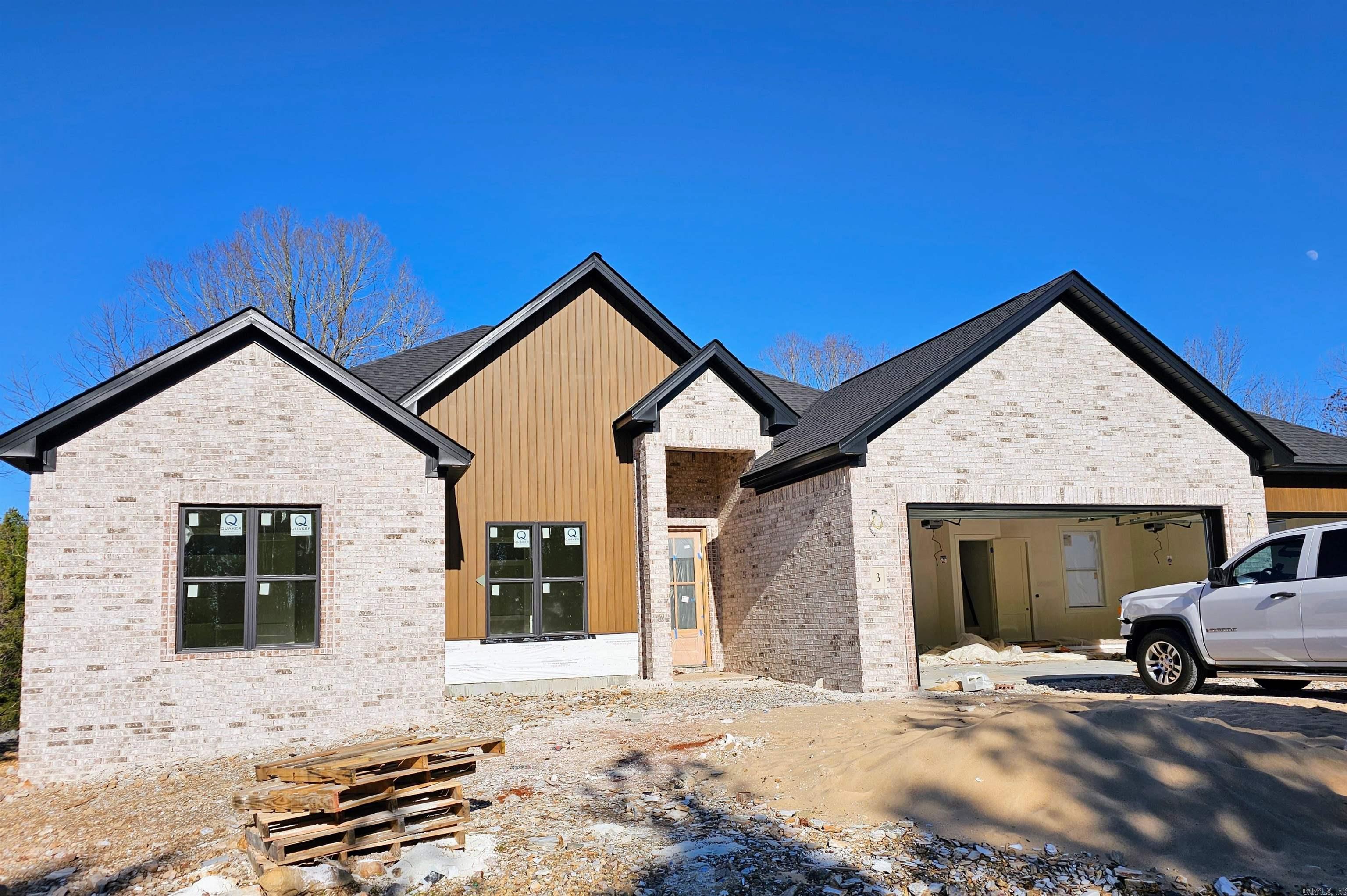 Welcome to modern living at its finest in this brand-new construction by Renaissance Homes, one of the premier builders in Hot Springs Village. Enjoy the spaciousness of a 3 bedroom, 2 bath home designed with an open floor plan, ideal for both daily living and entertaining. Features include volume ceilings with 8 foot doors; GE stainless steel kitchen appliances; separate laundry room; pantry; and a spacious 3 car garage providing ample storage and convenience. Walk up staircase to attic storage. Low maintenance exterior with Brick and Mac Metal Siding. Located on Moreno Way, this neighborhood offers spectacular vista and mountain views and a serene setting. Cooper Nature Preserve is directly behind and seen from the large covered patio. Builders 1 year Home Warranty included. Come see all this quality built home has to offer!