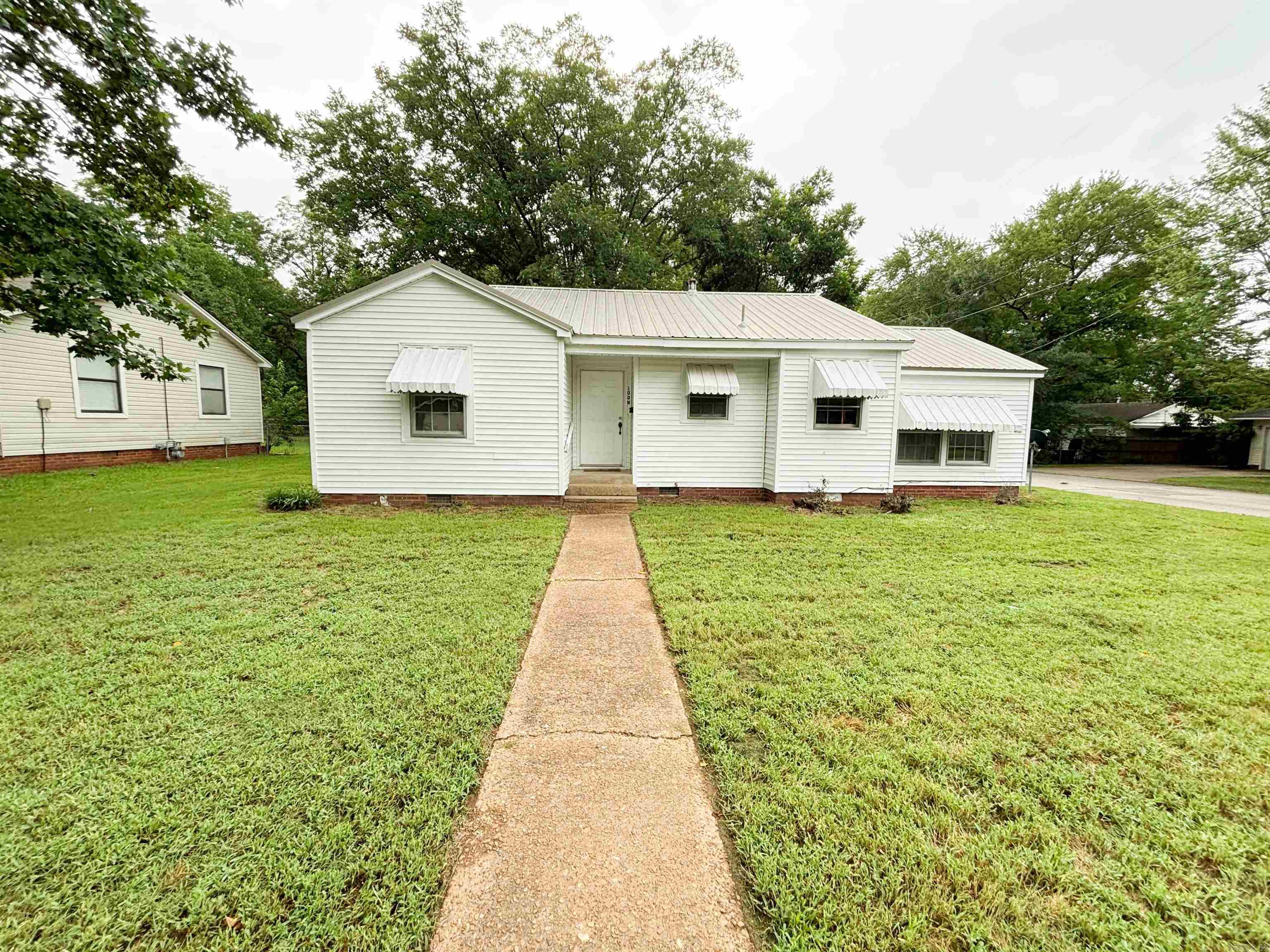 Located on a corner lot, this charming cottage features three bedrooms, two bathrooms and a carport. This HOME is perfect for EVERYONE! Whether you are a first-time buyer, investor, college student, young couple or someone looking to downsize or have always wanted an Airbnb, this is your opportunity! Close to Walmart Neighborhood Market, 10 Fitness, Southwest Middle School, Barb's Barbecue, Janett and Larry Crain Library and West Beebe-Capps has much more! Make your appointment today! This home will not last long and qualifies for Rural Development, FHA loans plus conventional loans, and cash is accepted.