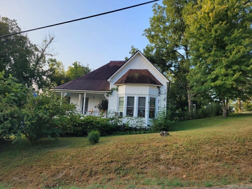 Come See this Victorian Charmer, there aren't many like this left around! It has had many updates but has kept a lot of Victorian features, like the wrap around porch with the original ceiling, and the bay window to mention a few. The Windows have been replaced and the Kitchen has been updated and has new appliances, flooring has been replaced, and the Sewer lines have been replaced. It has a spacious living room and two bedrooms with a bonus room that could be used as a bedroom or hobby room, You decide! It has a double lot and an older garage and some of the yard is fenced for children or pets. Calico is a historic town and this home is just a few blocks from the White River and downtown, and only 9 miles to Lake Norfork!