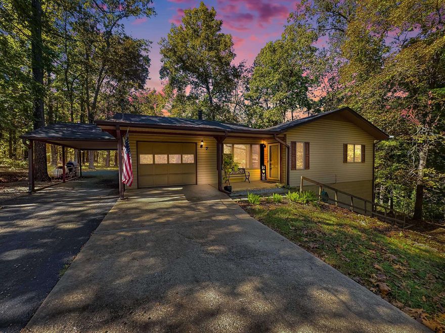 Welcome to 7 Owego Circle, a beautifully crafted two-bedroom, two-bath home nestled in the heart of Cherokee Village, Arkansas. Set on two spacious lots totaling nearly one acre, at the back of a charming cul-de-sac, the home features a wide driveway, one-car garage, and an additional one-car carport. The structure itself boasts solid bones and timeless architectural charm, wit thoughtful details throughout. Details include 2" blinds that match the trim, exquisite kitchen cabinets featuring a swing out pantry, metal siding, and so much more! Step out back to enjoy a deck overlooking a new expansive 85x65 fenced yard, complete with raised garden beds and a variety of fruit trees including cherries, figs, plums, and peaches. Inside, you'll find a finished walkout basement that serves as heated and cooled living space, offering flexibility for hobbies. The crawlspace is exceptionally accessible - tall enough to stand in - adding to the home's practicality.  BRAND NEW architectural shingle roof ensures peace of mind, while the cozy fireplaces add warmth and ambiance. This property blends comfort, functionality and location in one exceptional offering.