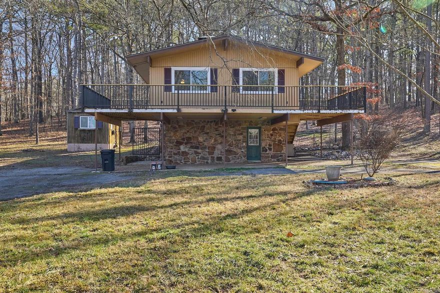 Welcome to your dream home nestled in the trees.  This remodeled residence offers the perfect blend of modern and comfort.  This Three Bedroom, Two Bath Home Features, a Modern Kitchen, Sleek Counter Tops, Spacious Cabinetry.  The Living Area Offers Vaulted Ceilings with a Massive Stone Fireplace.  The Master Suite is Located on the Second Floor for the Perfect Retreat.  Everyone will love the Expansive deck that wraps around the front and side of the home, perfect for entertaining and a great outdoor oasis.  The outside offers a nice storage building and a great fenced yard for any pets.  Home backs up to the State Park,  Your backdoor neighbors will be an abundant of wildlife.  Call today for a showing!!