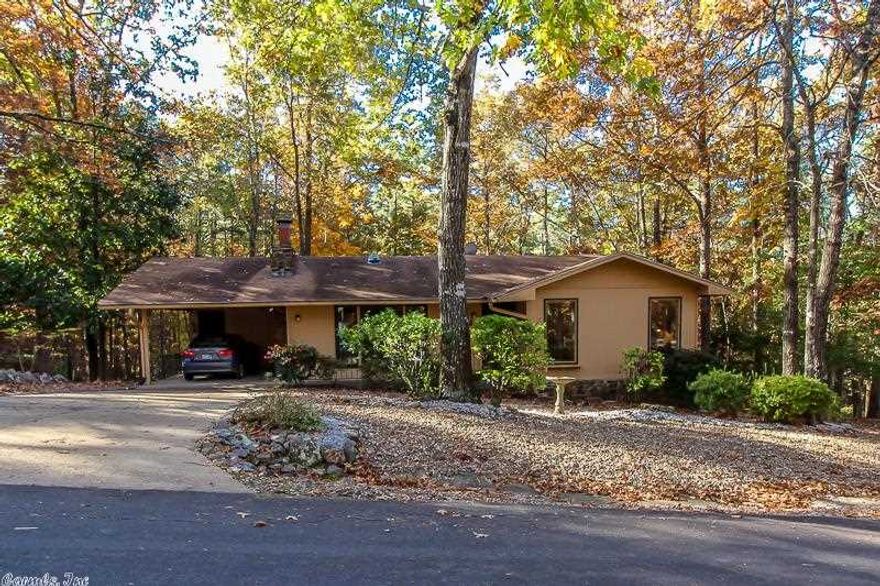 PREPARE TO BE SURPRISED....VAULTED CEILINGS, LAMINATE FLOORING, GAS RANGE, GAS LOG NATIVE STONE FIREPLACE,LARGE BEDROOMS AND ARKANSAS ROOM. LOTS OF STORAGE. WONDERFULLY MAINTAINED. NICE PRIVATE DECK OVERLOOKING COMMON PROPERTY. HANDY WORKSHOP LOCATED BELOW THE HOUSE. 2 BEDROOM WITH 2 BATHS AND CARPORT.