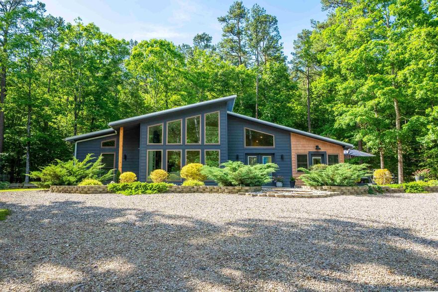 Active AirBNB by Lake Ouachita - Ouachita Springs Cabins! Nestled in the woods on approx 49 acres bordering the National Forest and only 4 miles from beautiful Lake Ouachita sit these adorable cabins that are ready for new ownership! Currently set up as an active vacation rental with great rental history and plenty of room to expand! Two, 600 sq foot A-frame cabins with full kitchen, full bath and loft bedrooms. One 800 sq foot A-frame cabin with full kitchen, full bath and loft bedroom and main home with 3 BR and 2 bth. All 3 cabins have hot tubs and large decks w/ plenty of privacy. Main home features open concept living/kitchen with quartz countertops vaulted ceilings and gas log fireplace. Main home would make another great rental or keep as your primary residence. Home built in 2020 and cabins built within the past 4 years.Gated entrance and perfectly situated between Brady MTN Resort and Crystal Springs Resort & a short 20 minute drive to beautiful downtown Hot Springs. Property borders the National Forest and Mulberry Creek runs through the front. Plenty of room to expand and add more cabins or build your dream home and bring in income. So many options!