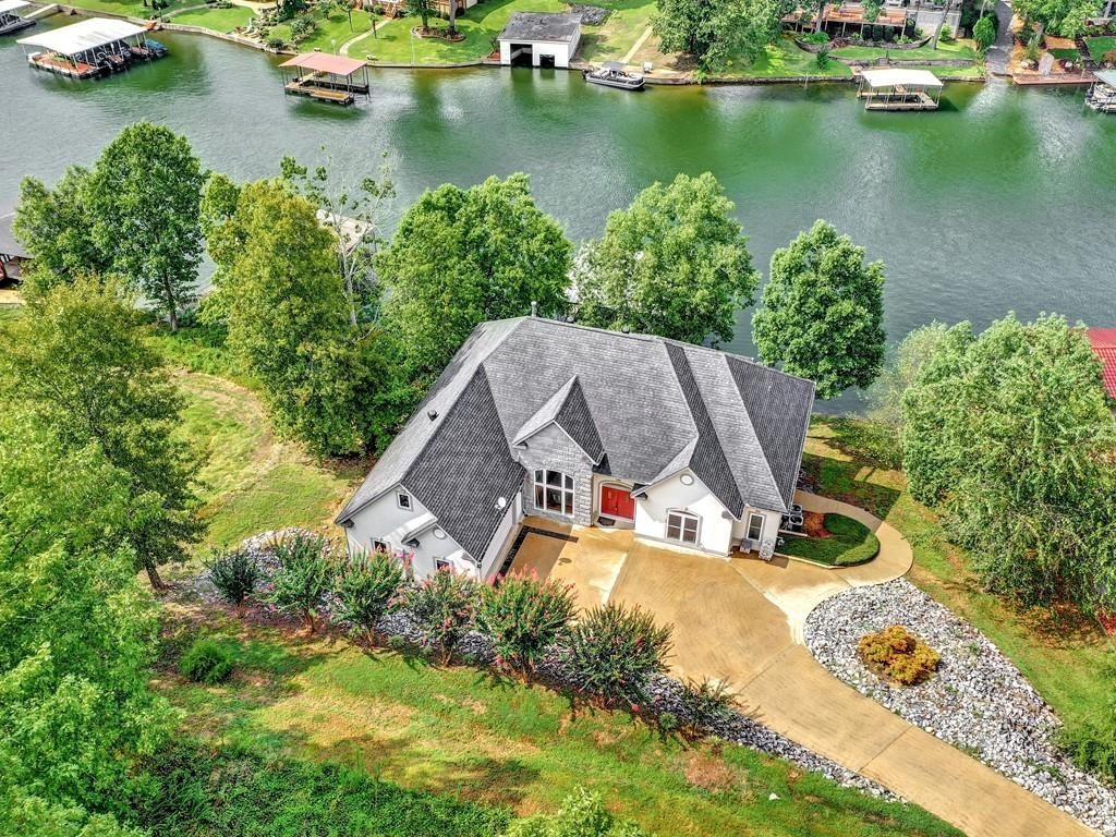 Waterfront Home in Stonegate Subdivision! Oversized living room features an open floor plan with gas fireplace and a wall of windows overlooking Lake Hamilton. Large kitchen and dining room for big gatherings or entertain on the sunny upper deck. Master bedroom has gas fireplace, private lake view, and en suite bath with Jacuzzi tub. Downstairs family room has a wet bar, fireplace, large private BR, 2 bathrooms & easy access to shaded patio and 2 stall covered boat dock. Winter water and off main channel.