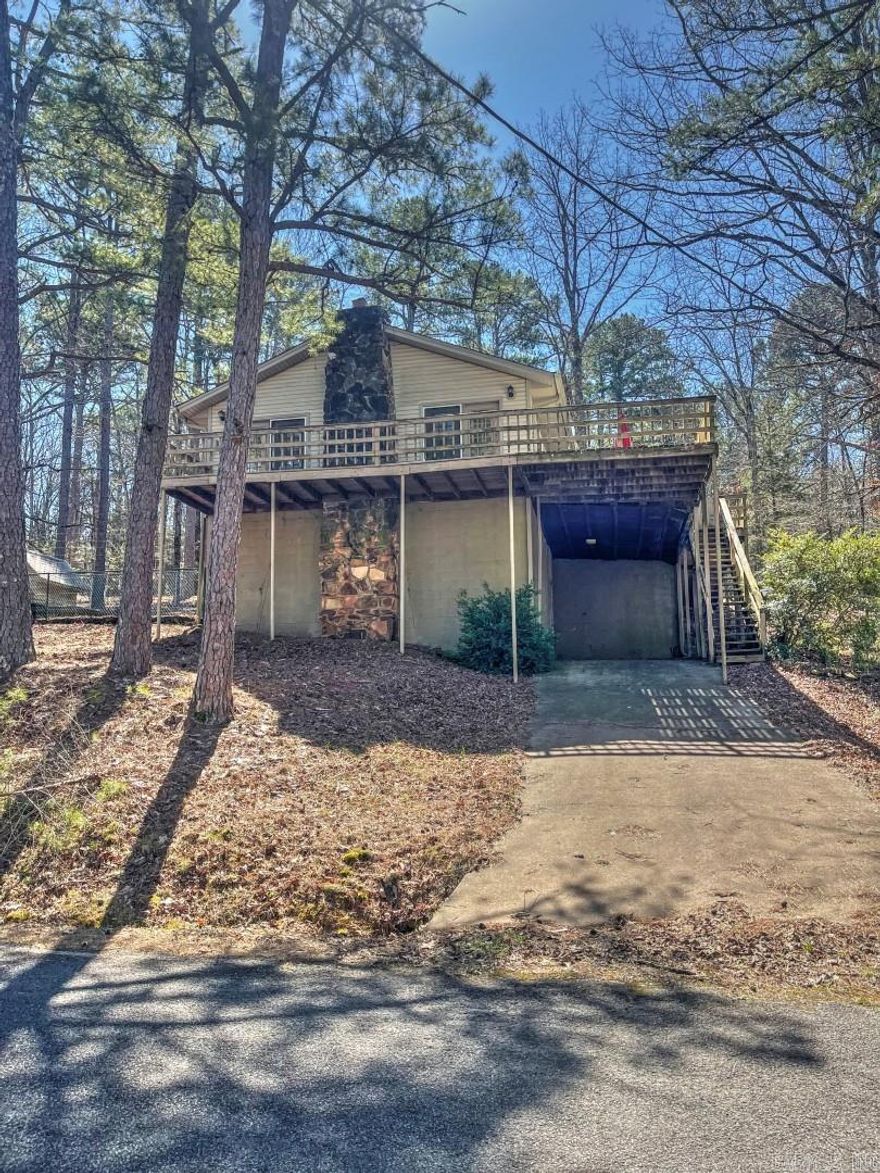 Discover your own slice of paradise with this secluded home, nestled among the trees for ultimate privacy & tranquility. Start your day sipping coffee on the deck, surrounded by the peaceful sounds of nature. Located less than a mile from Fairfield Bay Marina, you’ll have quick access to the lake, adding an element of adventure to your everyday life. This beautifully renovated home (2014) boasts modern amenities, including new windows, a new roof, updated flooring, & a cozy fireplace with gas logs. With a new water heater & A/C unit, year-round comfort is assured. Convenience meets functionality with a back driveway for ground-level entry & a front carport with crawlspace, perfect for storing lake gear & toys. Outdoor enthusiasts will love the proximity to local hiking/biking trails. Fairfield Bay offers 90 miles of ATV/UTV  as well as opportunities for golfing with our 2 18-hole golf courses, & miniature golf. Enjoy lake activities on pristine Greers Ferry Lake. We also have pickleball & three swimming pools & bowling,  Immerse yourself in an active, yet peaceful lifestyle at Fairfield Bay. Come take a look today & see all the possibilities this home has to offer!
