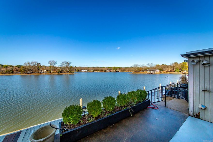 Coveted, gated Moonlight Bay Condominium located on the shores of Lake Hamilton. Experience waterfront living in this beautiful, updated 2 bedroom, 2.5 bath condo and enjoy the breathtaking, panoramic lakefront views from the den, covered patio and master bedroom. Updates include custom window treatments, quartz counters, lighting, and white oak floors, new dishwasher, new hot water heater, replaced front window. There are two large outside storage rooms on the patio. This convenient location in the heart of Lake Hamilton is just minutes away from downtown Hot Springs, Oaklawn, restaurants, shopping and entertainment venues for the entire family.  This a perfect blend of lake living and enjoying what Hot Springs has to offer.  Private boat ramp located on property.  No nightly rentals. See Agent Remarks.