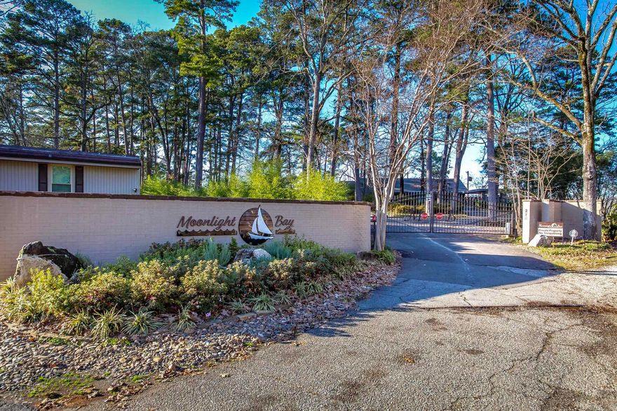 Coveted, gated Moonlight Bay Condominium located on the shores of Lake Hamilton. Experience waterfront living in this beautiful, updated 2 bedroom, 2.5 bath condo and enjoy the breathtaking, panoramic lakefront views from the den, covered patio and master bedroom. Updates include custom window treatments, quartz counters, lighting, and white oak floors, new dishwasher, new hot water heater, replaced front window. There are two large outside storage rooms on the patio. This convenient location in the heart of Lake Hamilton is just minutes away from downtown Hot Springs, Oaklawn, restaurants, shopping and entertainment venues for the entire family.  This a perfect blend of lake living and enjoying what Hot Springs has to offer.  Private boat ramp located on property.  No nightly rentals. See Agent Remarks.