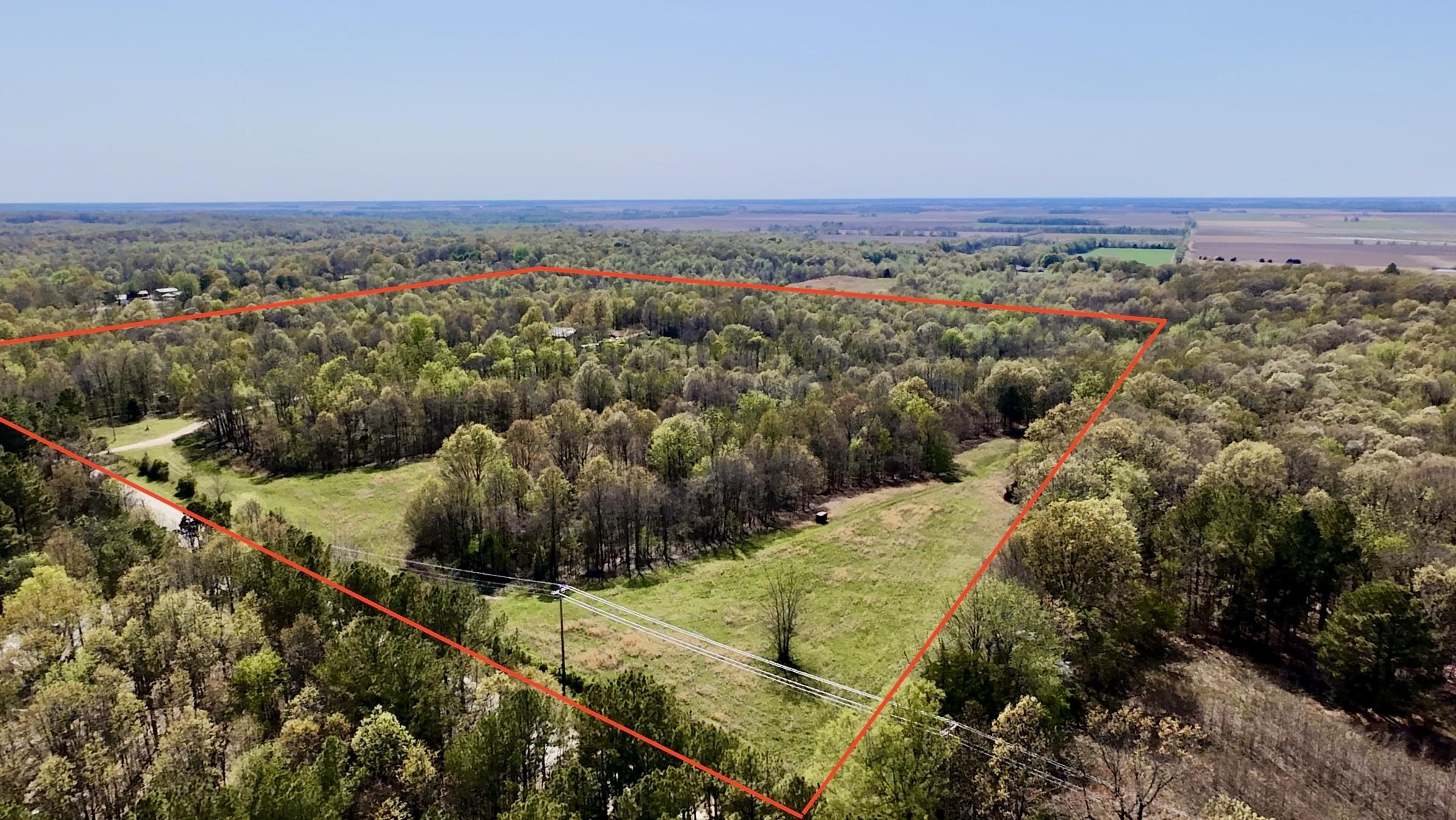 40 Acres of Prime Land with Rolling Hills, Paved Access, Multiple Build sites, Large Pond & Abundant Wildlife - Your Private Retreat Awaits! Welcome to your dream property! Nestled on Hasbrook Rd, this stunning 40-acre parcel offers the perfect blend of natural beauty, accessibility, and opportunity. With rolling hills, wide-open cleared fields, a year-round spring, and a large pond, the landscape is as functional as it is picturesque. Whether you're looking to build your dream home, start a mini-farm, or simply enjoy a private getaway, this land checks all the boxes. Multiple ideal building sites are scattered throughout the property, giving you flexibility and inspiring views in every direction. Access is easy with paved road frontage, and utilities available at the road make future development simple and cost-effective. A solid barn offers convenient storage for equipment or supplies and adds rustic charm to the setting. Outdoor enthusiasts will appreciate the abundant wildlife - the property is full of deer and turkey, making it a hunter's paradise or perfect for peaceful nature observation. More acreage available if interested! Or willing to subdivide into different tracts!