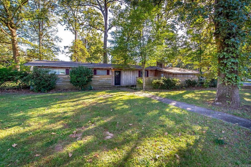 This cozy home sets on a corner lot with a spacious yard, and a big shop! Conveniently in the middle of town, and just right down the road from the White River! Call me, or your favorite agent for your private showing today! This place won't last long! (501)454-7782