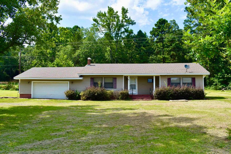 Perfect starter home on investment property on 1.74 acres. Large living room overlooks vast front yard. Big kitchen opens up to eating area with an additional office or sunroom on the back. 2 bedrooms and 1 bath. Large garage with extra storage. Big back yard with trees along back for privacy. New roof 2019. New flooring kitchen & laundry.  Home being sold "As Is"