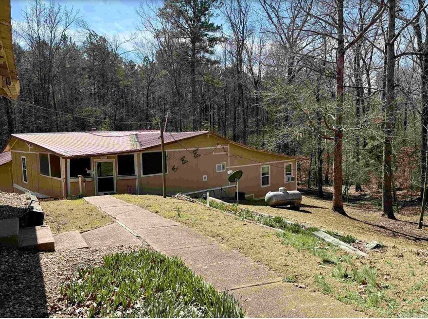 This is a true hidden gem surrounded by nature! This inviting home features two master suites, each with its own full bath, plus a guest bedroom and guest bath for visitors. Inside, enjoy both a spacious living room and cozy den, giving you plenty of room to relax or entertain. Step outside to the large screened-in porch for morning coffee or unwind on the covered grilling deck while soaking in the sights and sounds of the countryside. Just a short walk to the Saline River, this property is perfect for those who love to fish, explore, or simply enjoy abundant wildlife. Whether you’re looking for a peaceful weekend escape, a hunting or fishing camp, or a quiet full-time home, this place has it all. Come experience the calm, beauty, and simplicity of country living at its best — schedule your visit today!