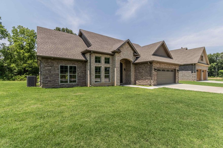 Custom-Built Beauty in Creekwood Subdivision Step into luxury with this stunning custom-built home nestled in the desirable new Creekwood Subdivision. Featuring 4 spacious bedrooms and 3 full baths, this residence boasts a semi-open concept layout centered around a soaring stone fireplace that adds warmth and elegance. The gourmet kitchen is outfitted with high-end Frigidaire Professional appliances, striking granite countertops, a walk-in pantry, and a cozy breakfast nook perfect for daily living or entertaining. The elegant primary suite is your personal retreat, complete with a spa-like tile walk-in shower and relaxing soaker tub. Upstairs, you'll find an iron rod-railed balcony overlooking the main living area, an office nook ideal for working from home, and a versatile bonus room. Enjoy outdoor living on the inviting covered patio with decorative stamped concrete flooring. Built for comfort and efficiency, this home includes a tankless water heater, spray foam insulation throughout, and a finished attic lined with T38 sheeting. This custom home is truly a must-see!