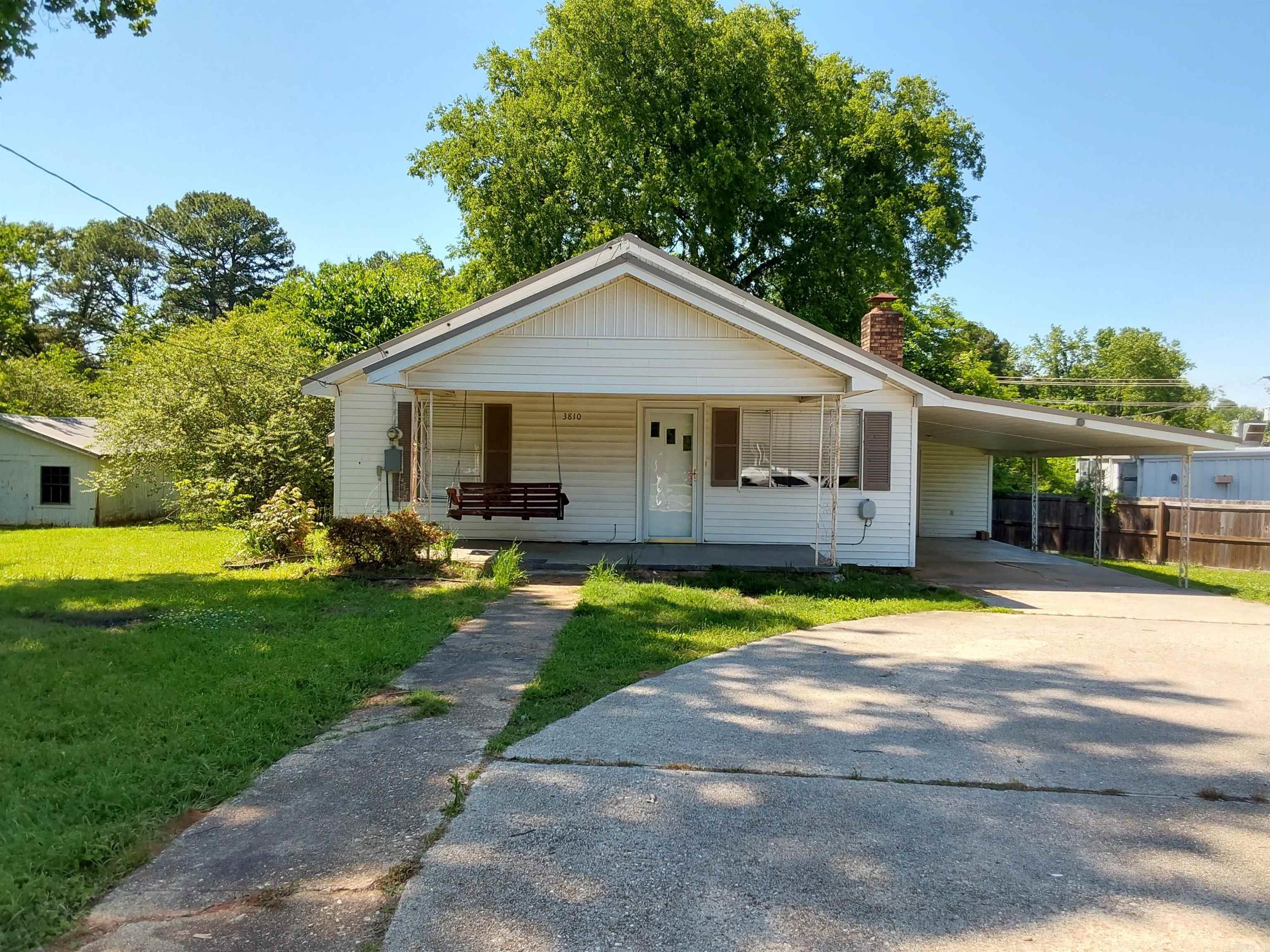 Charming and move-in ready! This super cute 2-bedroom, 1-bath home sits on a spacious 0.6-acre lot and features a metal roof and HVAC system replaced in 2016. The newly remodeled bathroom includes a beautiful walk-in tiled shower, and the entire interior has been freshly painted—including the kitchen cabinets. Cozy up by the ventless gas log fireplace, and enjoy the convenience of a 1-car carport, on-site shop, and partially fenced yard. Home is being sold AS-IS, WHERE-IS.