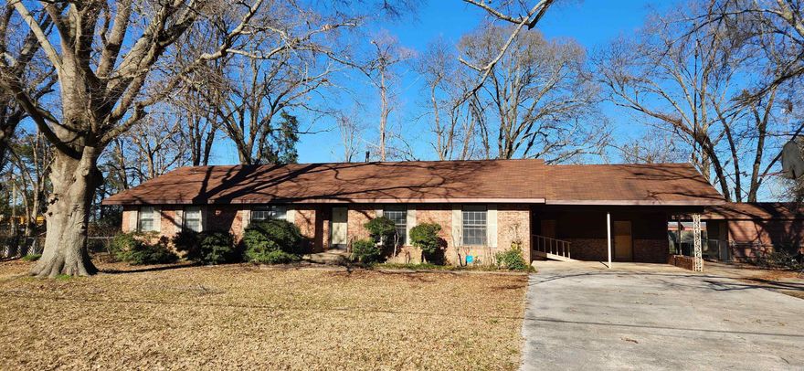 This home is Priced to sell and just awaiting a new owner for some TLC!!! It has a Huge living room, with hard wood flooring underneath the carpet. Kitchen has built in oven and stove top. There is also a pantry and 2 dining rooms which one could be used as office/craft room. 3 large bedrooms with 2 big closets in each one. 2 baths.  The  Hall has built in shelving for all your reading and collectables. Double Carport with storage room. Beautiful Back yard that is fenced for your children to play or pets to run. Also, there is a cute play house that can finish out for children's sleepovers. Another large out building with electricity and  lots of plug ends, concrete floor and it can easily be fixed up for office/game room or guests.