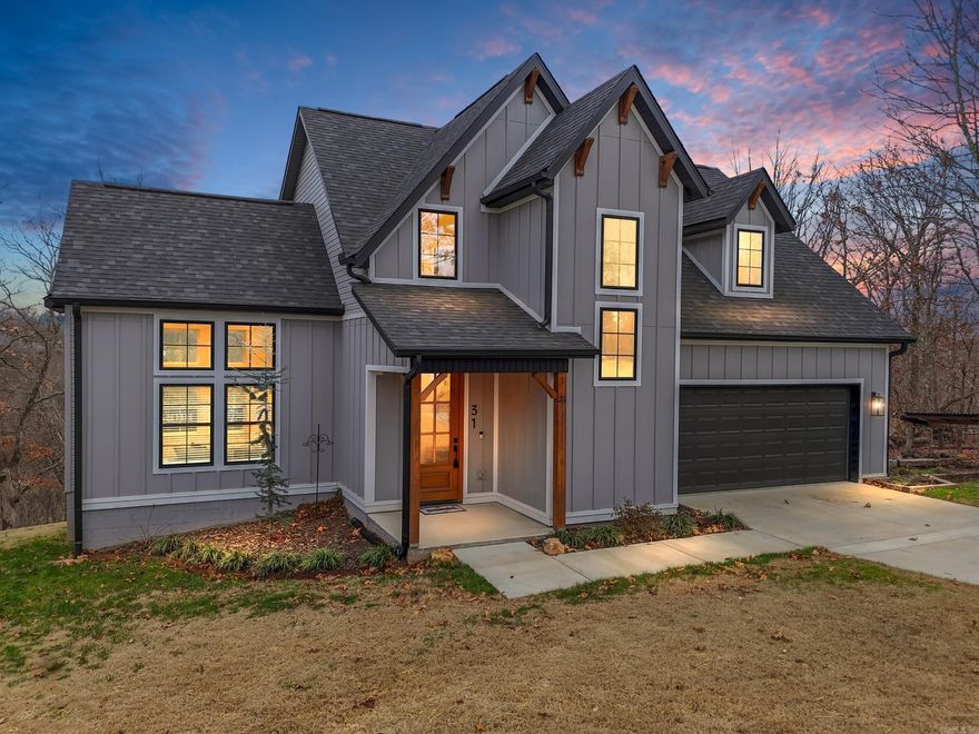 Unwrap the perfect Christmas gift—your new home in sought-after west Bella Vista!  This stunning modern 4-bedroom, 2.5-bath two-story home offers soaring vaulted, beamed ceilings and a bright, open layout ideal for gatherings accented by a gas fireplace. The kitchen features quartz countertops, custom tile, a gas range, and a refrigerator that stays for easy move-in. Enjoy smart conveniences like two washer/dryer connections (One in Primary Closet, One upstairs), double vanities in both full baths, a spacious primary suite with a huge walk-in closet, and an upstairs bonus room for an office or playroom. Step outside to a large private deck overlooking a large, tree-filled backyard with beautiful views and custom fire pit. Located just two minutes from Loch Lomond Lake, golf, clubhouses, fitness center, pickleball courts, and bike trails, this impeccably maintained home delivers the Bella Vista lifestyle! Other thoughtful upgrades include French drains, gutter guards, garage shelving, and double 100lb propane tanks for extended use between refills! New Construction Quality without New Construction pricing! Move-in ready and just in time for the holidays. Schedule your showing today!