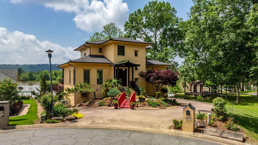 Welcome to this one-of-a-kind home in Maumelle! A uniquely designed home with a MILLION DOLLAR river view! This home invites in all the beauty of the Arkansas River and the gorgeous designs of the gardens that speak peace and tranquility. Soaring ceilings in the entry leads to a generous living area, custom kitchen with upper-end appliances and sleek finishes! Main level with office, formal dining and primary suite with luxurious bathroom with custom designs never seen before. Upstairs offers two bedrooms with full bath, lower level offers a guest suite with tub and separate walk-in shower. Private patio off guest room. Outside you can enjoy relaxing on the huge deck off the main level as you take in the evening sunsets. Other features include a sprinkler system, workshop, and so many extras! Stunning river views from the comfort of your home await you!