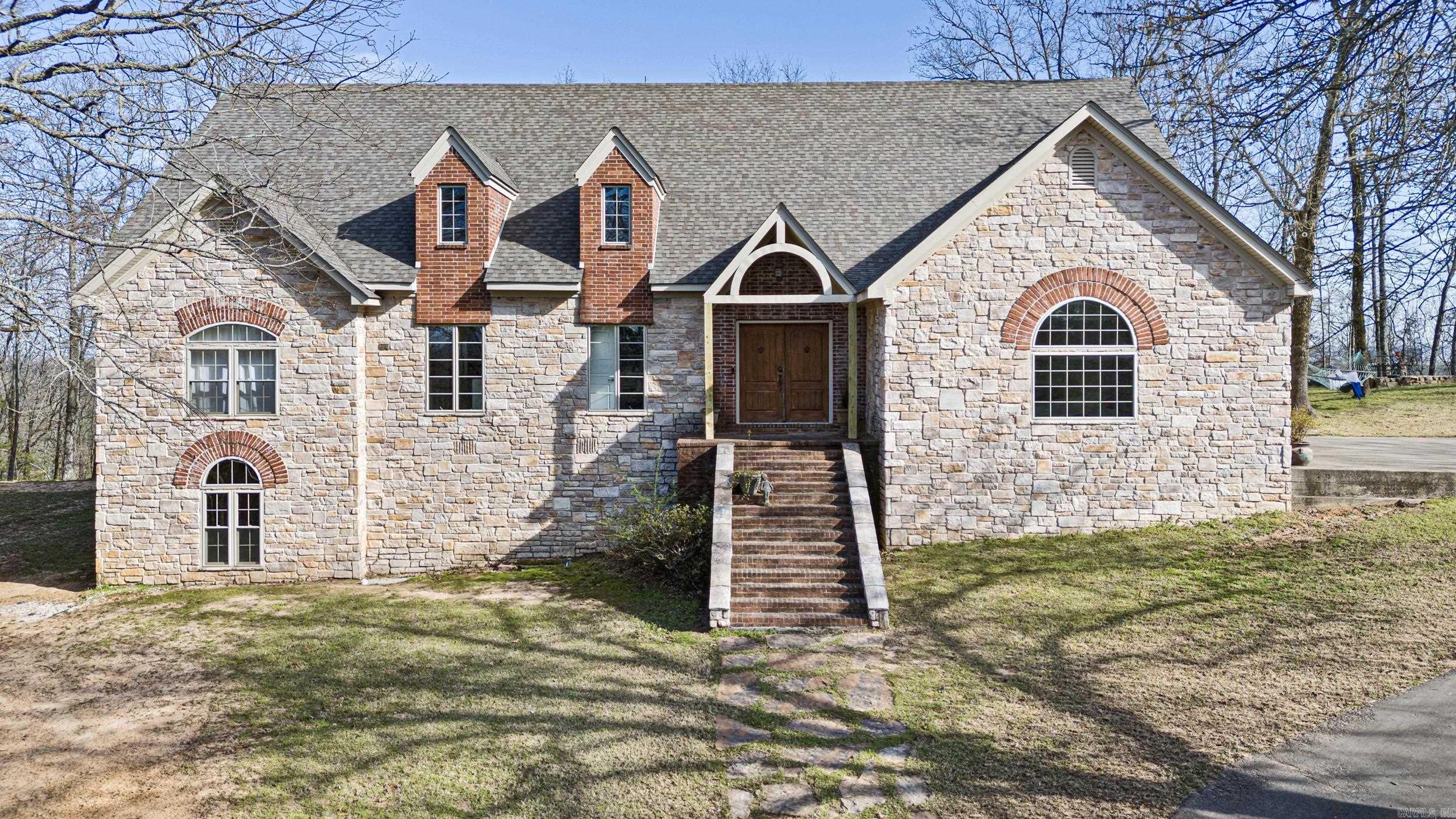 Back on the MarketāNo Fault of the Seller! Seller is motivated!! Now listed below appraised value, this breathtaking custom-built 4 bedroom and 4 bathroom home offers privacy and convenience, just one mile from the freeway and restaurants. This home is designed for comfort and style and has an open floor plan with a walk-out basement. Soaring 14ā ceilings in the living room, 12ā in the kitchen/dining, and 10ā throughout create an airy feel. The primary suite (12āx22ā) boasts a fireplace, wall of windows, and His & Her walk-in closets. The walk-out basement includes a den/game room, bedroom, and full bath. Enjoy quartz countertops, custom cabinetry, a huge pantry, and crown molding throughout. Extra insulation (2x6 walls) keeps energy costs low. The 12āx24ā deck offers stunning wooded viewsālike living in a treehouse!