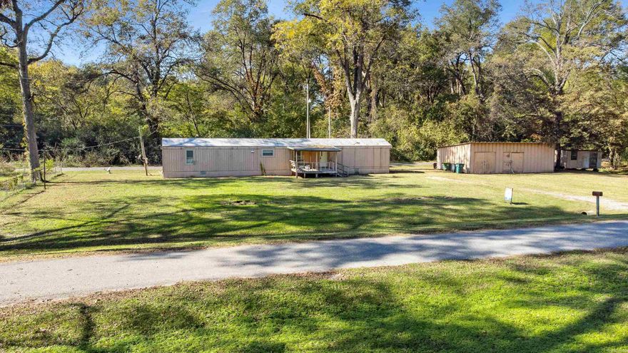 Affordable country living in Scott! This 3BR/2BA manufactured home sits on nearly ½ acre with a large shop, perfect for storage, hobbies, or a workspace. Offering approx. 1,064 sq ft, it features a functional floor plan and great potential for first-time buyers, investors, or anyone ready to make it their own. The spacious lot provides plenty of room for a garden, pets, or outdoor entertaining. With a little TLC, this property could shine as a comfortable home or solid rental. Conveniently located near Old River Lake with easy access to Little Rock, North Little Rock, and Jacksonville—peaceful rural living just minutes from town.