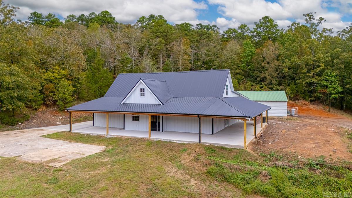 Tucked away on a private drive and surrounded by beautiful trees, this fully remodeled 4-bedroom, 2-bath home sits on 5 serene acres while being less than 20 minutes from downtown Conway, Maumelle, and Little Rock. A wrap-around front porch welcomes you with classic charm, while the metal roof and board-and-batten exterior add timeless appeal. Inside, the home has been completely updated for modern living. The master suite is a spacious loft retreat with its own sitting area and en-suite bath. The heart of the home is the kitchen, boasting butcher block countertops, stylish finishes, and space to gather. The enormous laundry room makes daily life easy, and the oversized garage provides plenty of storage and parking. Durable concrete floors flow throughout the main level, making the home practical as well as beautiful. Whether you’re enjoying the peace of your land, raising animals with the existing stables and chicken coops, or taking advantage of the quick access to shopping, restaurants, and freeways, this property offers the perfect blend of privacy and convenience.