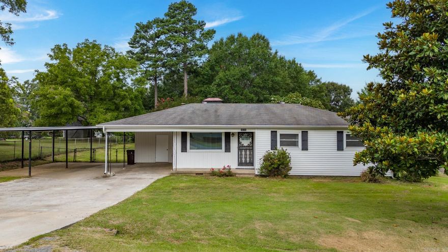 Welcome to your sanctuary! Experience the perfect blend of modern comfort & outdoor tranquility in this remarkable home, situated on a half-acre corner lot, providing you with the perfect blend of privacy and space where every day feels like a getaway.  Inside you will find two inviting living spaces designed for comfort and relaxation. The first, located just off the entry, is bathed in natural light & features built-in-bookshelves, perfect for showcasing your favorite reads & treasures. The second living space area, also adorned with built in shelves, boasts a cozy fireplace, creating an ideal setting for intimate gatherings or quite evenings at home.  Retreat to the primary suite, where an updated bath awaits, complete with a luxurious walk-in shower. The two additional bedrooms share a beautifully remodeled hall bath that has a relaxing tub/shower combo.  Step outside to your expansive covered patio, where you can unwind & enjoy the serene surroundings. The tree-lined yard is a true oasis, complete with a storm shelter & two storage sheds that convey.  Embrace a lifestyle of comfort, convenience and peace in this exceptional property!