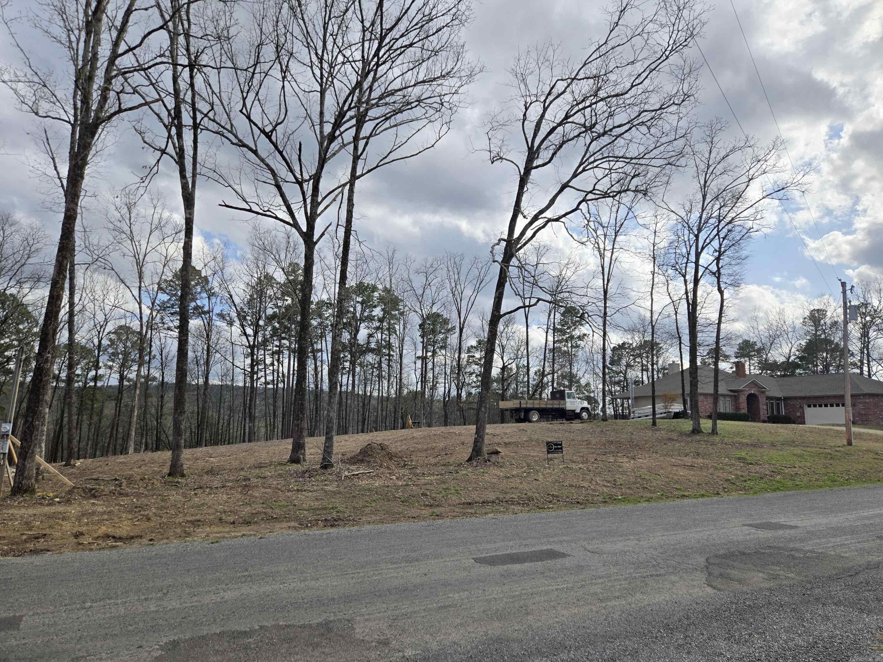 Nice subdivision lot for sale in the beautiful Diamondhead Gated Community in Hot Springs Arkansas. Already cleared and has a gentle slope so will easily accommodate a basic crawl space foundation for Building your dream home in Lakeside School District. This community offers private access, a PGA sanctioned 18 Hole Golf Course with driving range & Clubhouse - Large Swimming Pool, Tennis and Basketball Courts, Children's Playground & Beautiful Community Green Spaces. Lake Catherine State Park is 3 minutes away and offers camping, boat access & the most beautiful Hiking Trails. You will love the Nature of this Neighborhood - Builder Available and Spec Model Home is right next store for a limited time walk thru! Minimum Square Footage allowed is 1,200.