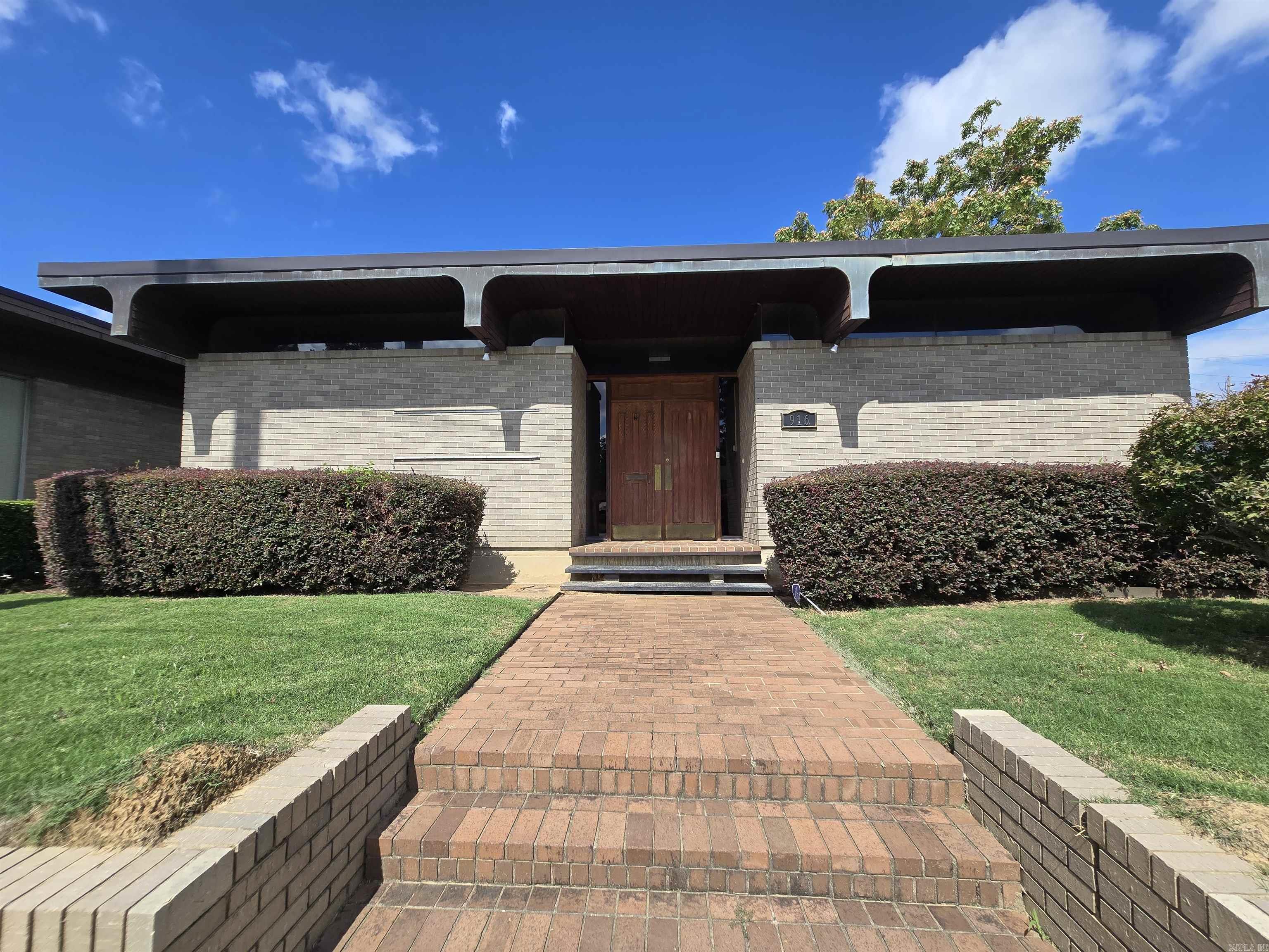 This mid-century modern building offers a distinctive space ideal for a law office, medical practice, or financial firm. Inside, it features stunning library paneling and unique ceilings that add character and warmth. The property includes four private parking spaces at the back for convenience. With high visibility from Cantrell Road and close proximity to downtown, it provides easy access for clients and staff.