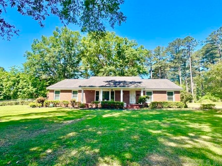 Beautifully maintained brick traditional home offering timeless charm, quality craftsmanship, and modern updates in a desirable quiet neighborhood close to all city amenities. This spacious 3BR/2BA home features an updated kitchen, two inviting living areas, and a formal dining room perfect for entertaining. Charming original details and rich woodwork add warmth and character throughout, while the cozy wood-burning fireplace creates the perfect gathering space. Step outside to enjoy the brick-covered patio overlooking the large partially fenced yard, ideal for relaxing or outdoor activities. Additional features include a 2-car carport with attached storage room and plenty of space for everyday living. A rare opportunity to own a classic home with enduring style and exceptional comfort.  Call today before this beauty is gone! Lot size, acreage, & square footage taken from courthouse records.