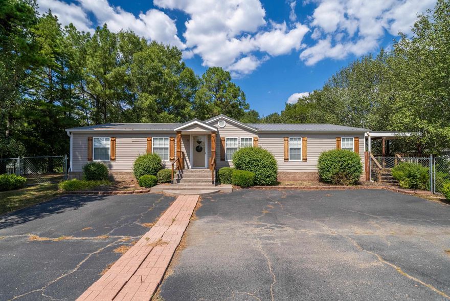 This charming mobile home features a large lot with ample space for gardening and outdoor enjoyment. The huge deck is perfect for entertaining or relaxing, while the large outdoor storage building and additional shed offer plenty of space for all your needs. Inside you will find generously sized rooms that offer plenty of space and comfort. POA covers water, subdivision septic system, mowing and lighting of the common areas. Also neighborhood has a fishing pond. Call today! *Metal Roof and HVAC both approximately 5 years old*