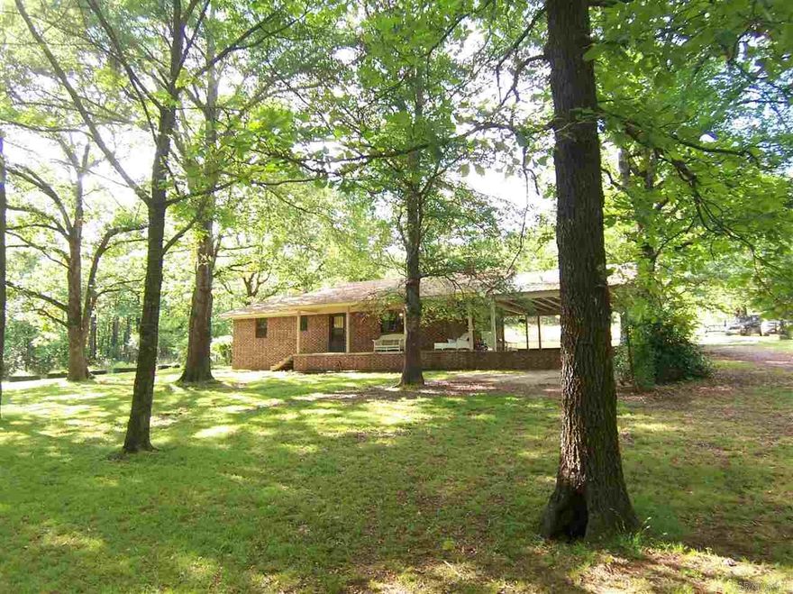 PERFECT Country home!!  BONUS ROOM!! Almost 2 acres at edge of town with garden spot, pond, dog kennels surrounded by wooded peace & quiet at end of country lane. Energy efficient 2X6 construction, huge carport, big front porch.  Has flue for wood stove.  New carpet and DSL internet!! VERY MOTIVATED SELLER BRING OFFERS!! See Agent Remarks.
