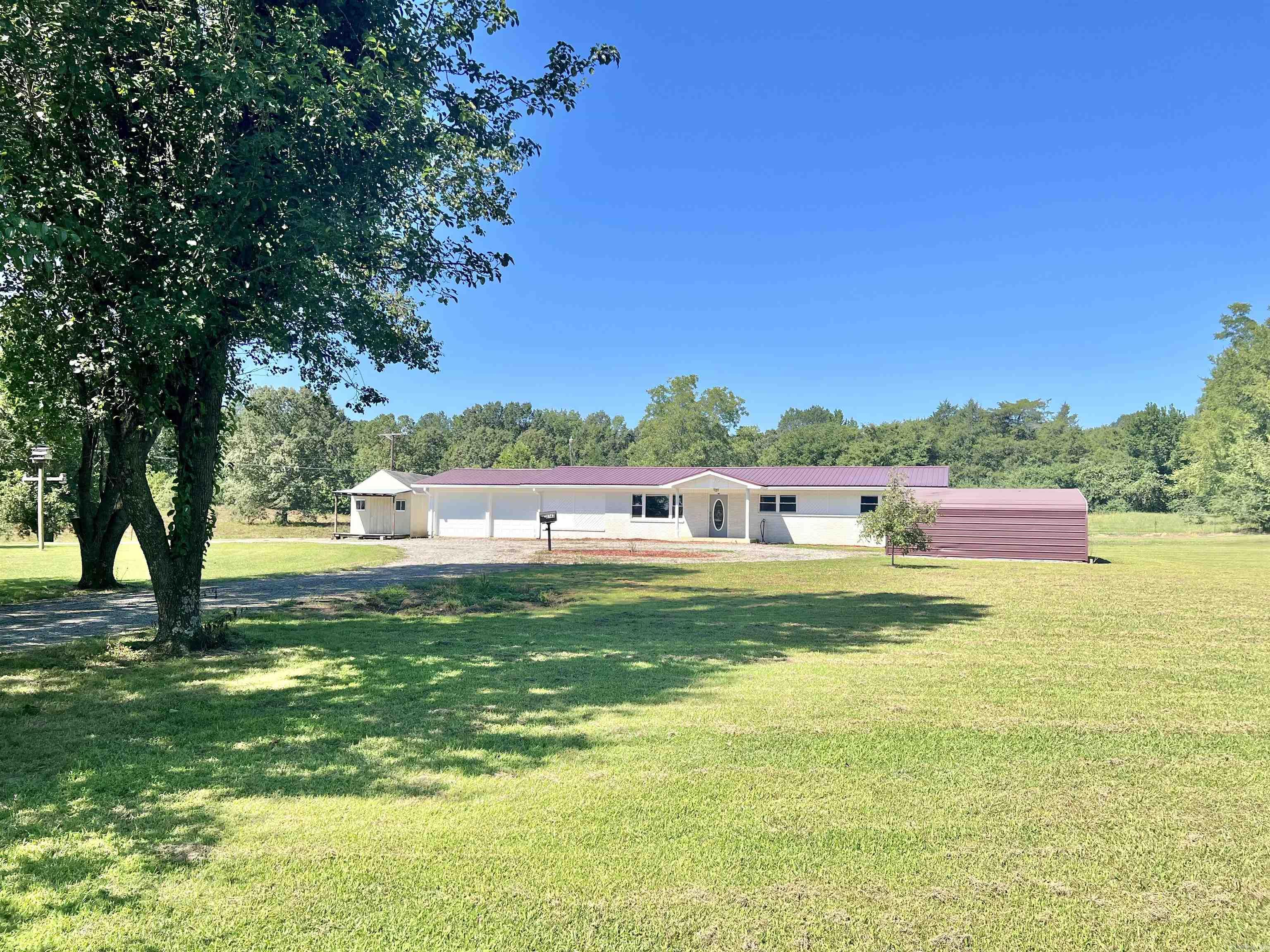 4-bedroom, 3-bath brick home on 5 acres, conveniently located near the Little Red River. This home offers two primary suites featuring their own ensuite bathrooms. All rooms are very spacious with ample closet space. The kitchen features a gas cook stove and wall oven, an eat-in breakfast area with a separate dining space open to the main living area. A 2-car garage ensures your vehicles are sheltered, while a versatile craft/hobby shop stands ready to accommodate your storage needs or transform into a she-shed, home office, or whatever your imagination desires. A spacious 60'x34' shop equipped with electric and plumbing sits at the back of the property. Additionally, a covered carport which would be a great space for your boat or equipment. Approximately 8 additional acres with a pond and an investment and/or second living quarters are available for purchase. Agents see remarks.